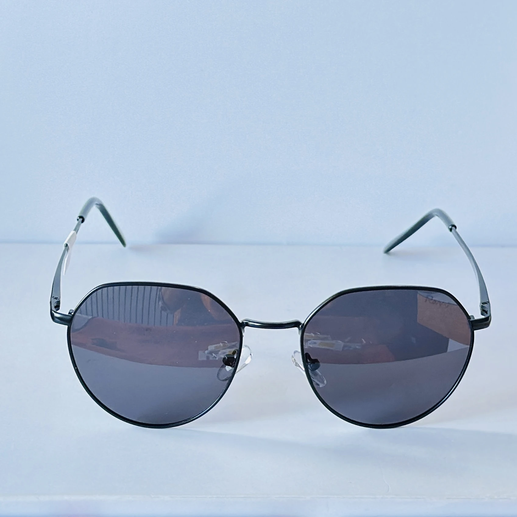 Ray-Ban style hexagonal sunglasses with a black metal frame.