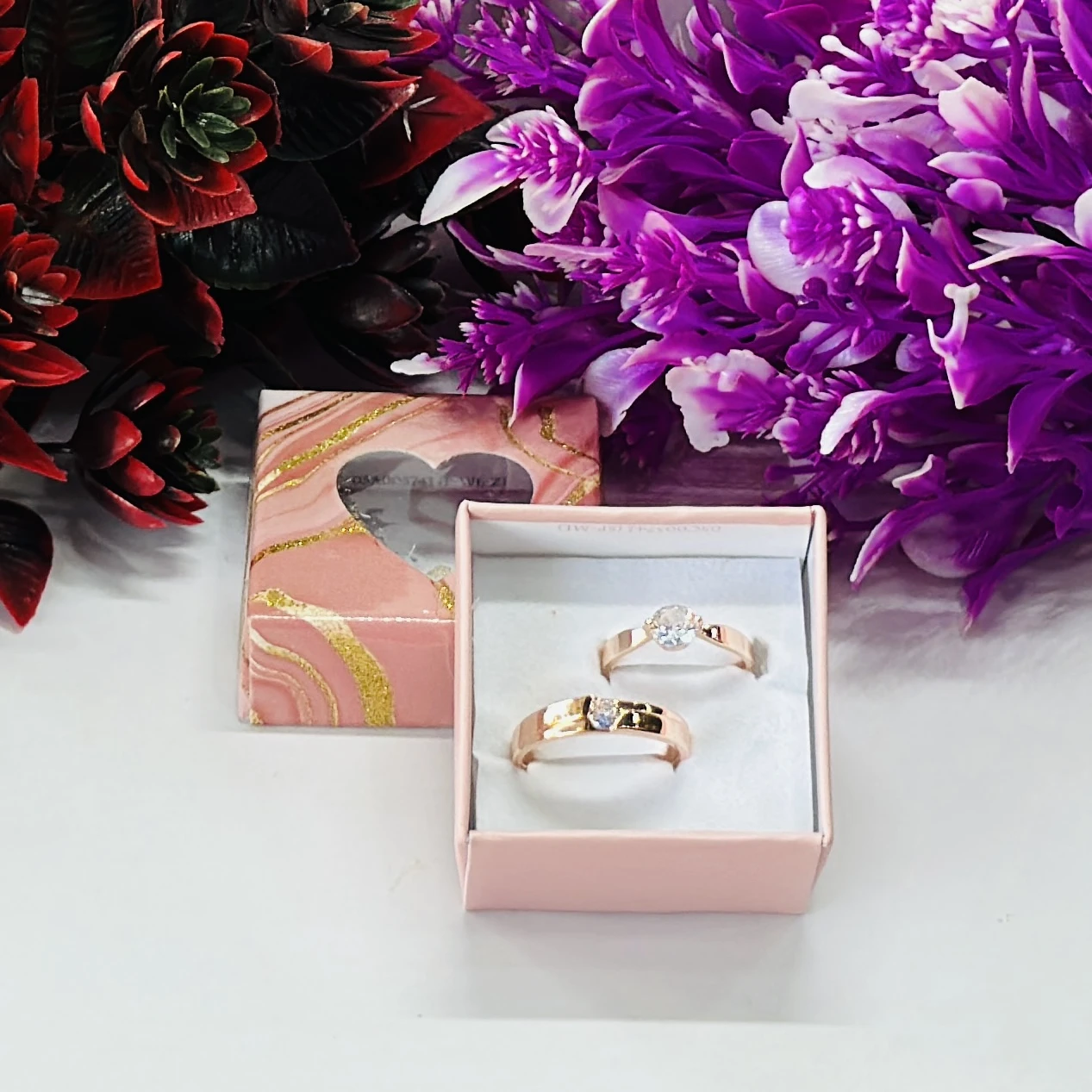 Rose gold-plated cubic zirconia couple rings.