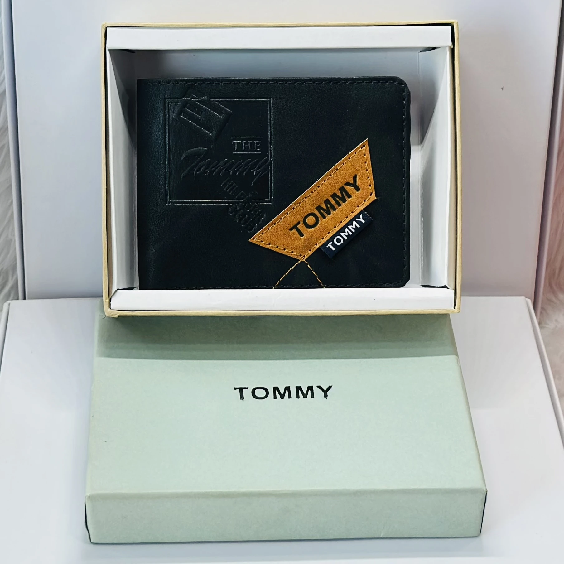 Tommy Hilfiger men's black leather bi-fold wallet.