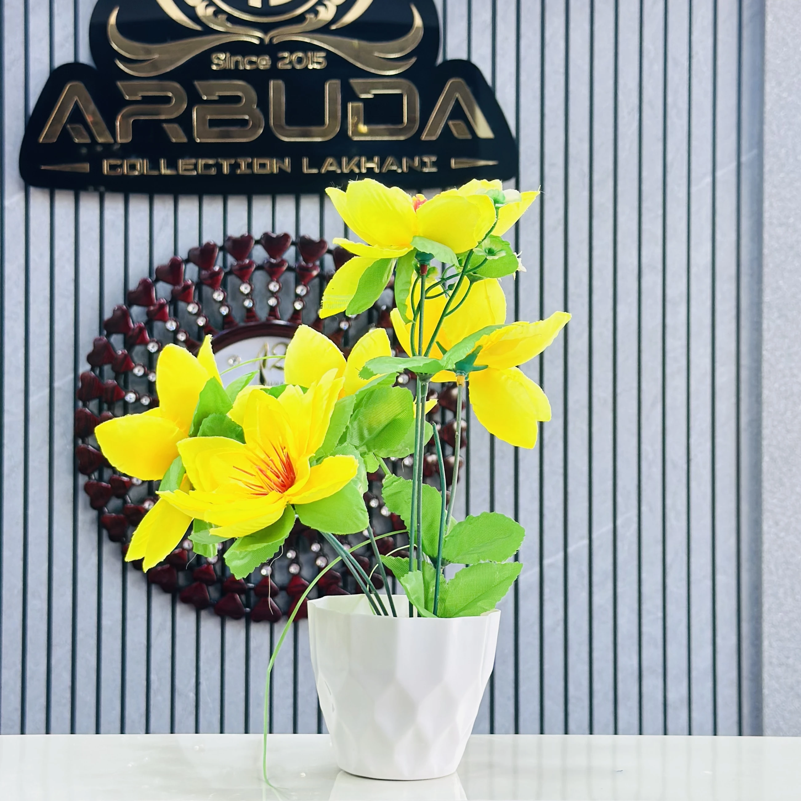 Yellow lily flower plant in a white pot.