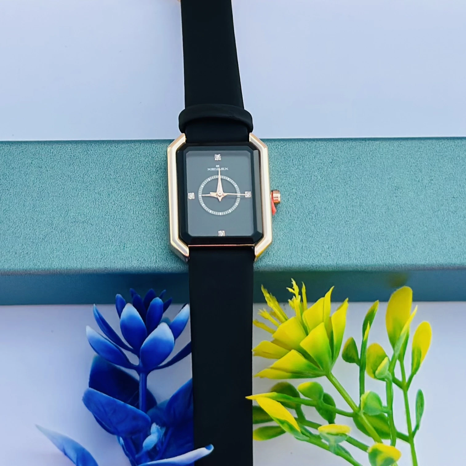 women's watch with a rectangular dial and a black strap.