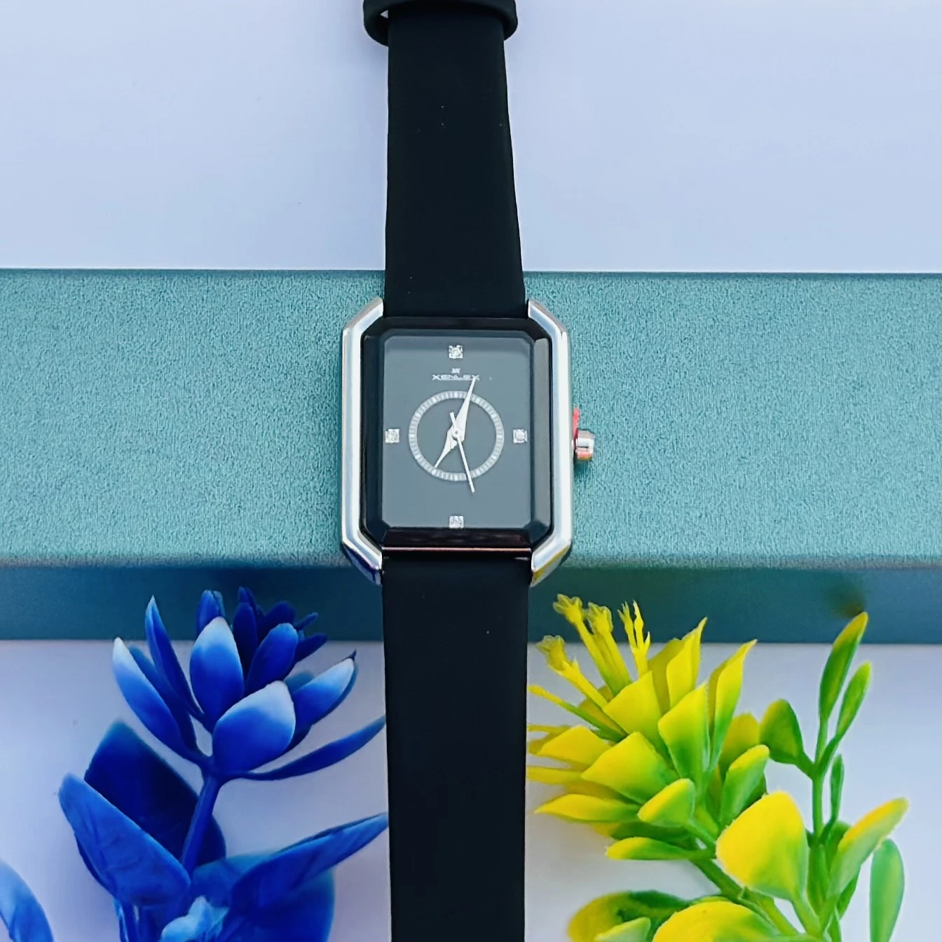 women's watch with a rectangular dial and a black strap.