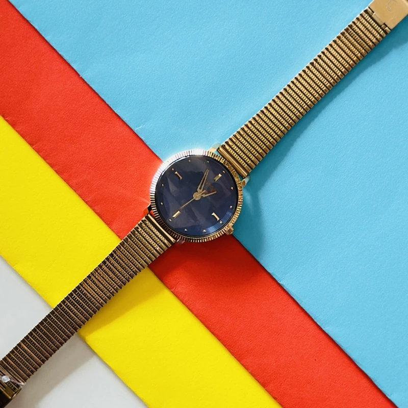 an elegant gold-tone analog wristwatch