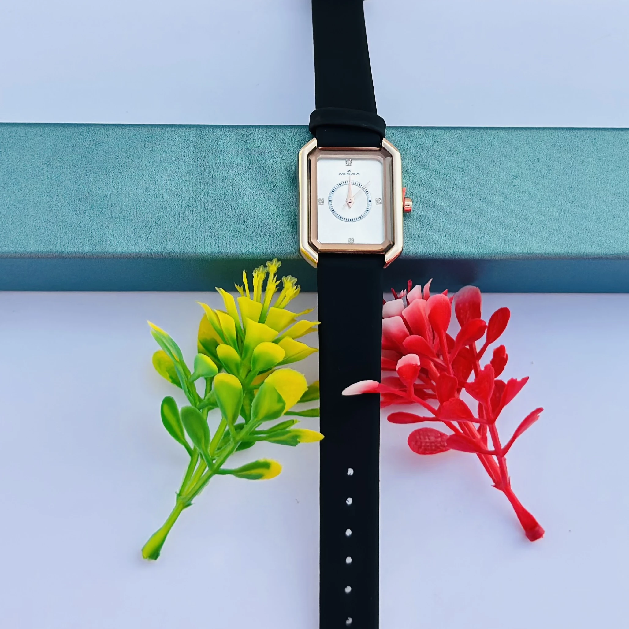 women's watch with a rectangular dial and a black strap.