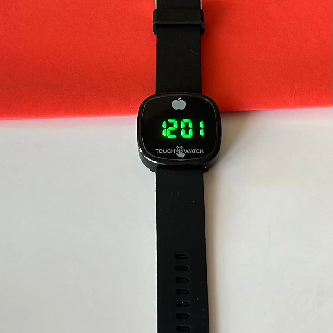Black digital wristwatch with a blue silicone strap.
