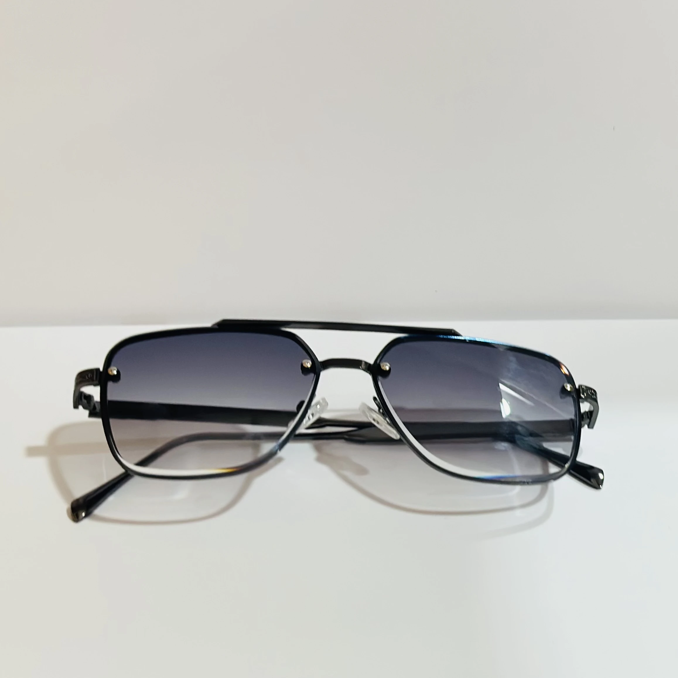 pair of black and grey gradient square sunglasses with a metal frame.