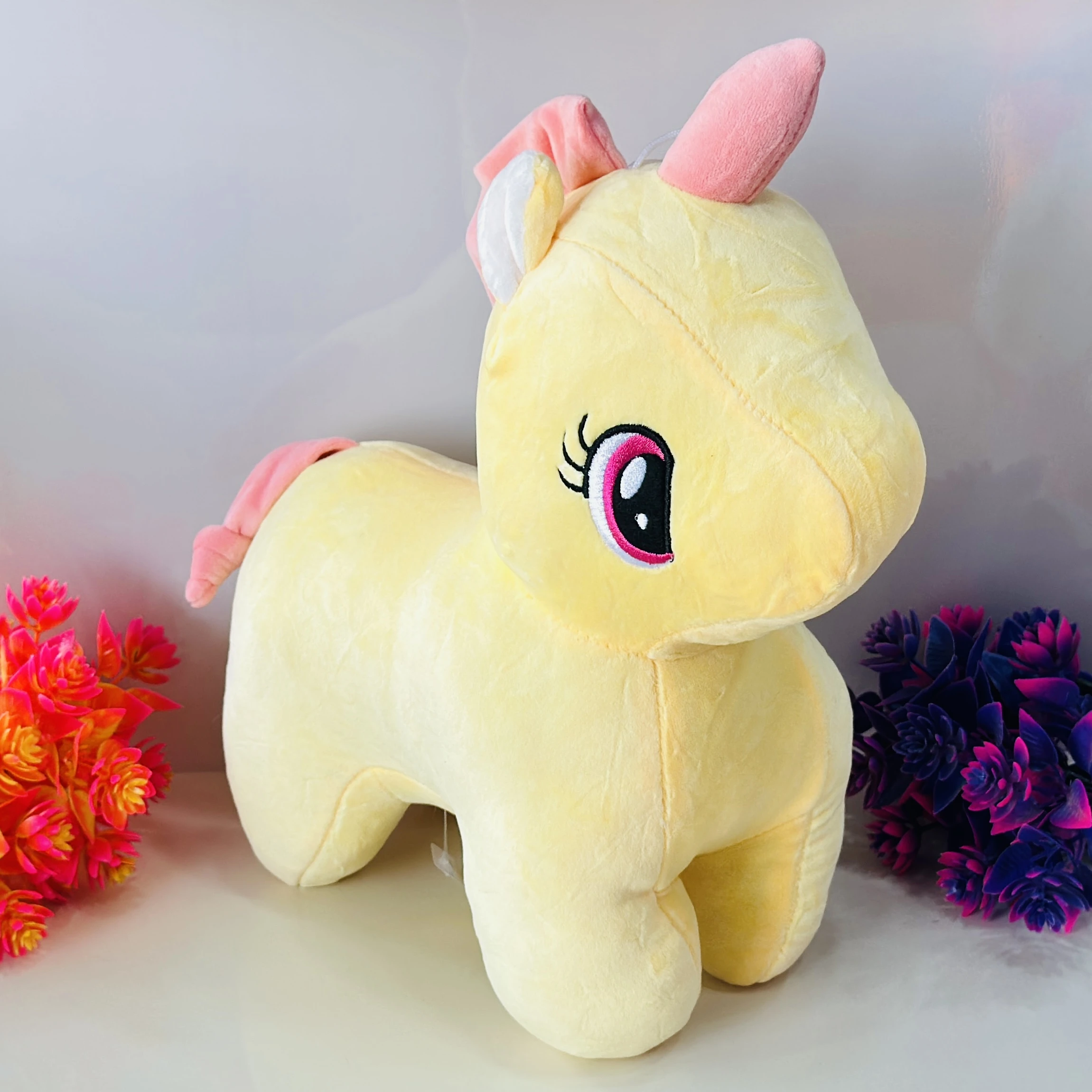 Yellow plush unicorn soft toy