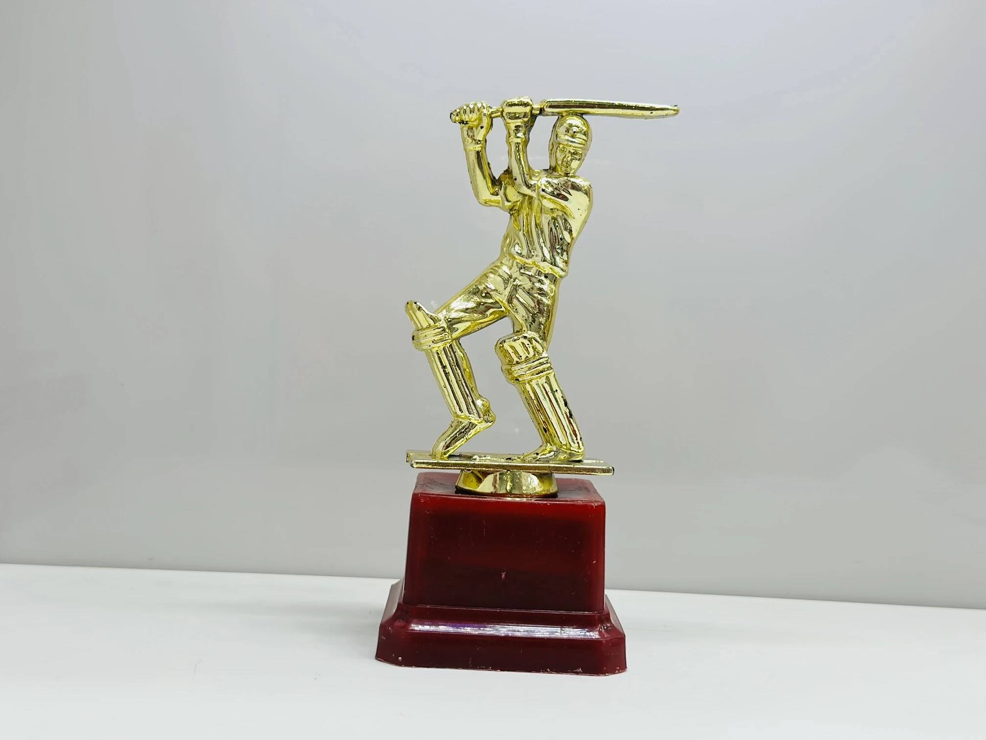 cricket trophy featuring a batsman figure.
