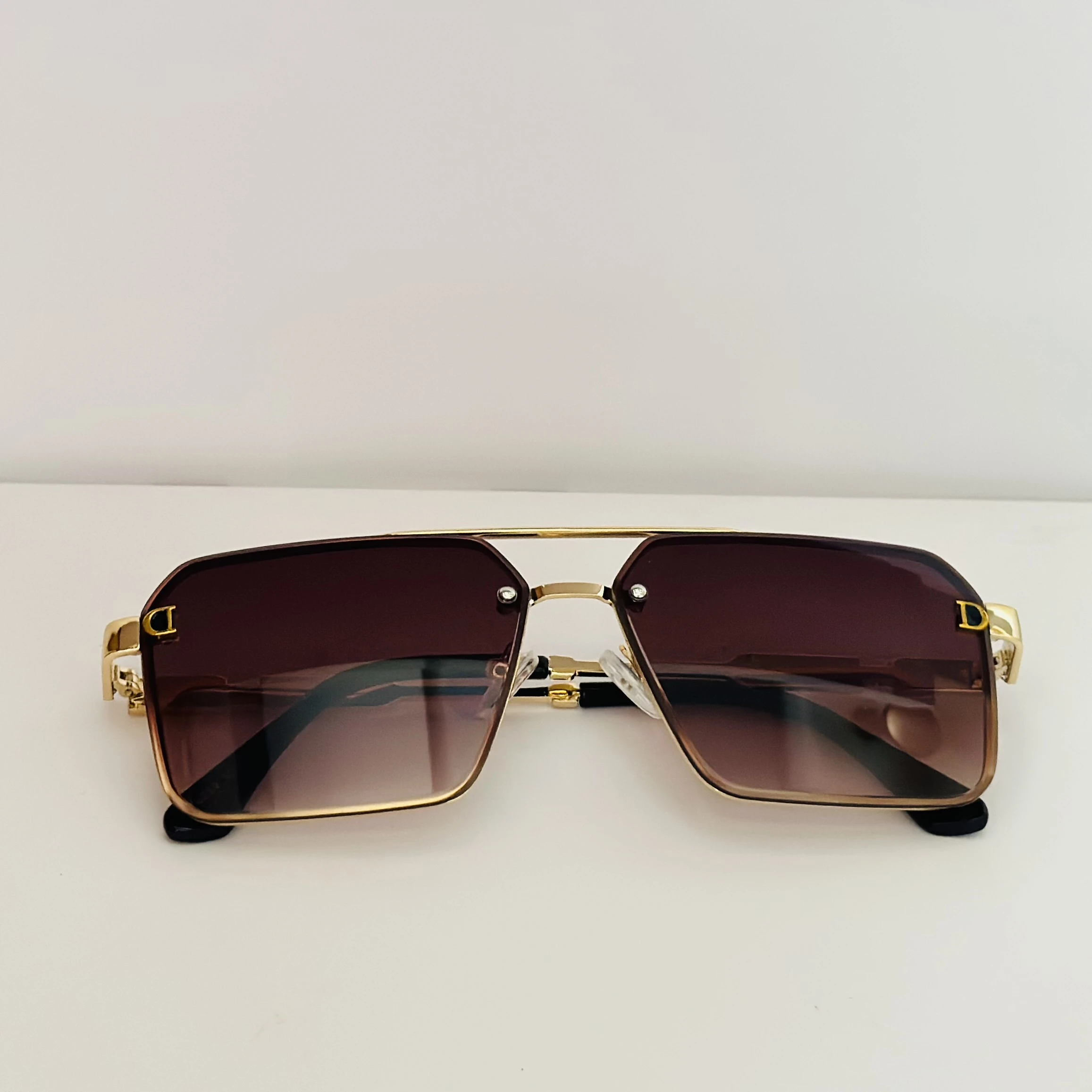 Gold Frame brown gradient lens oversized square sunglasses with black temple arms.
