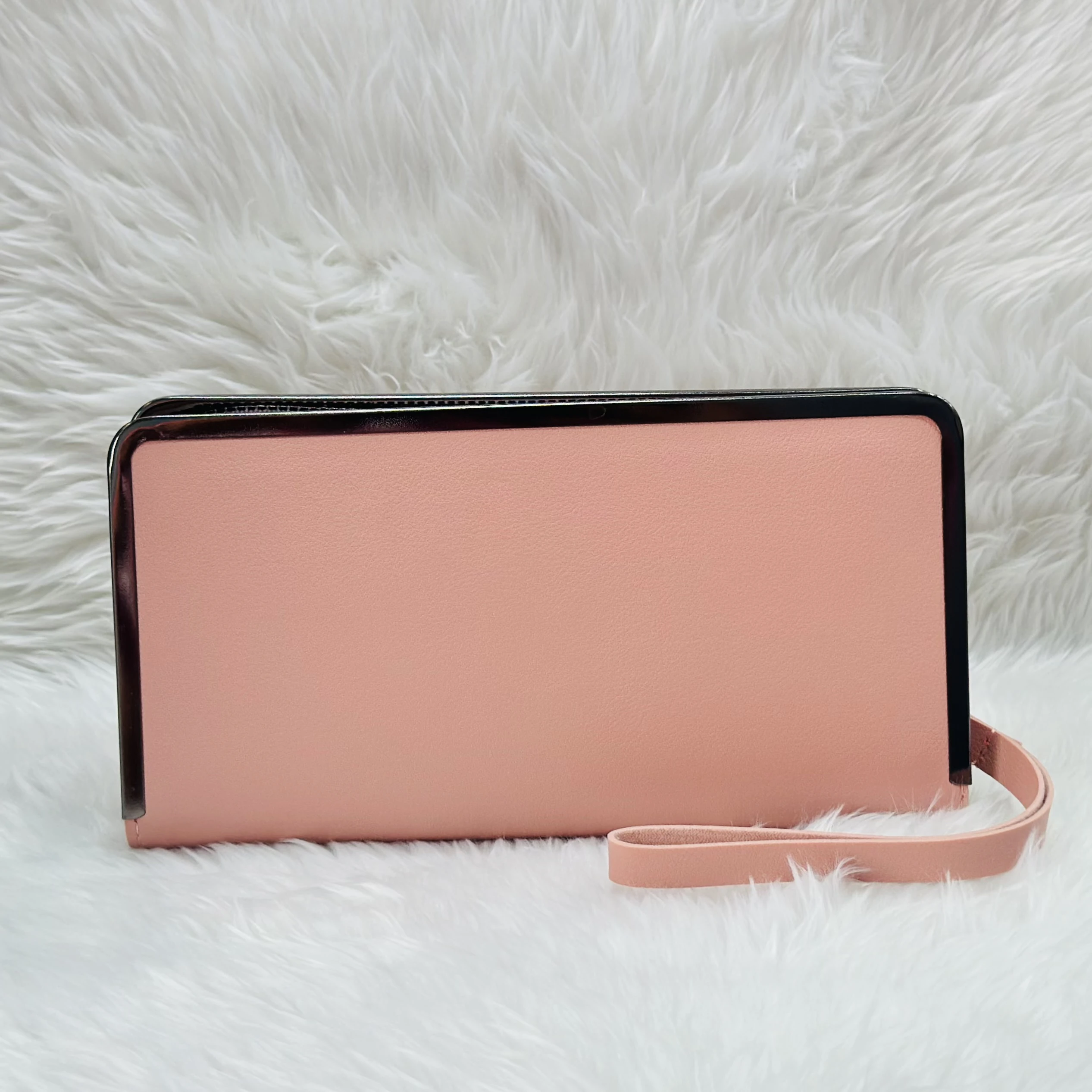 Brisfine pink clutch wallet in polyurethane outer material.