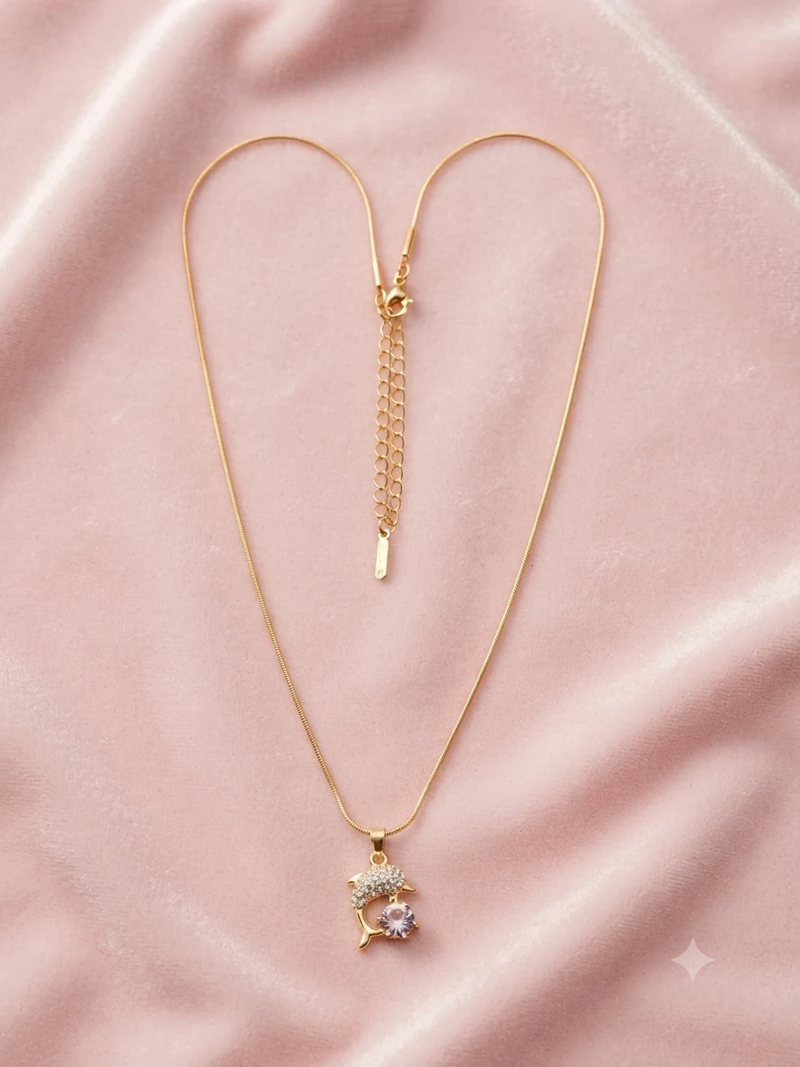 Gold plated necklace features a dolphin pendant