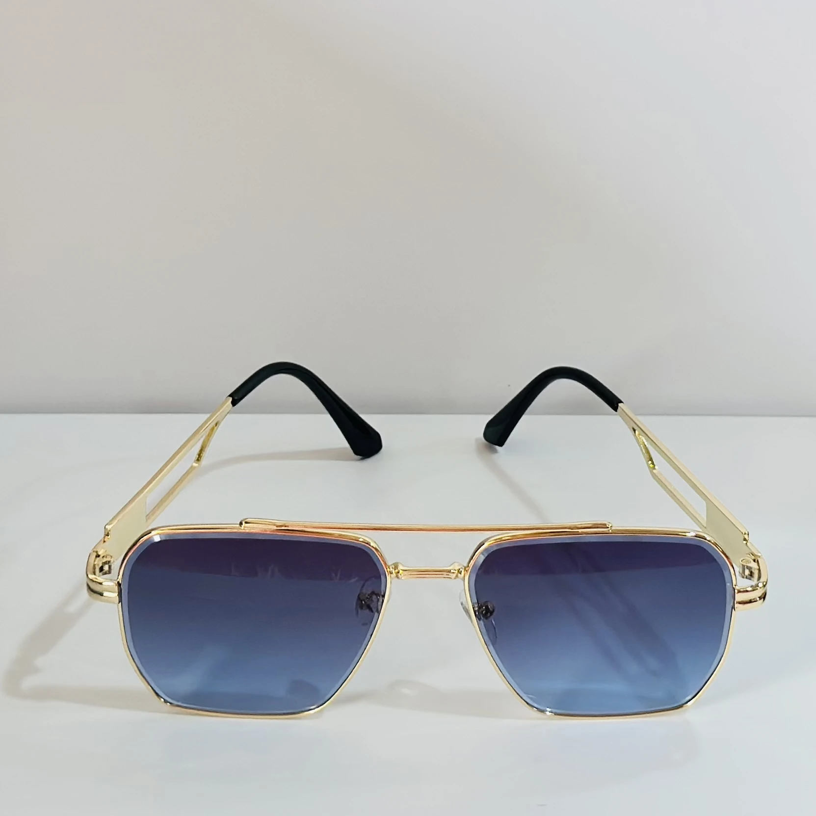 pair of gold-toned aviator sunglasses with gradient lenses.
