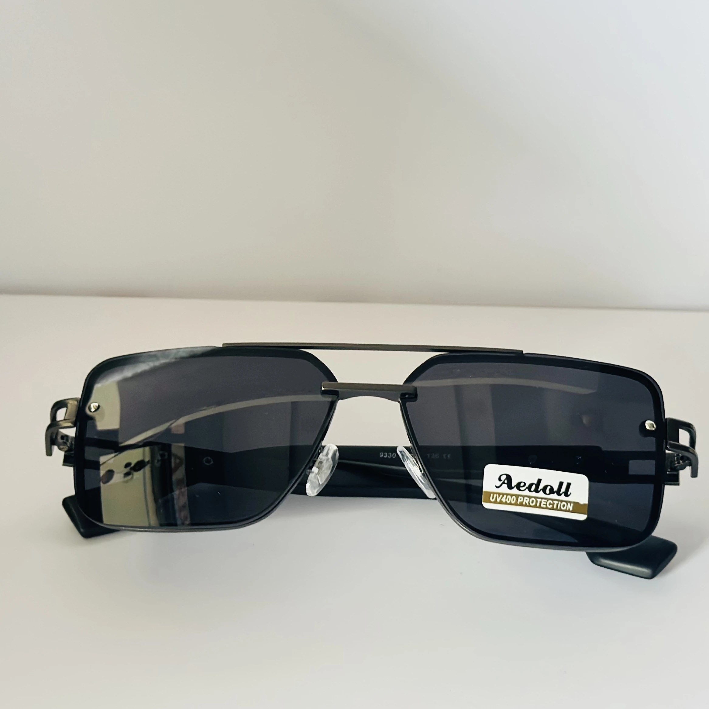 pair of square aviator sunglasses with a black metal frame and gradient lenses.