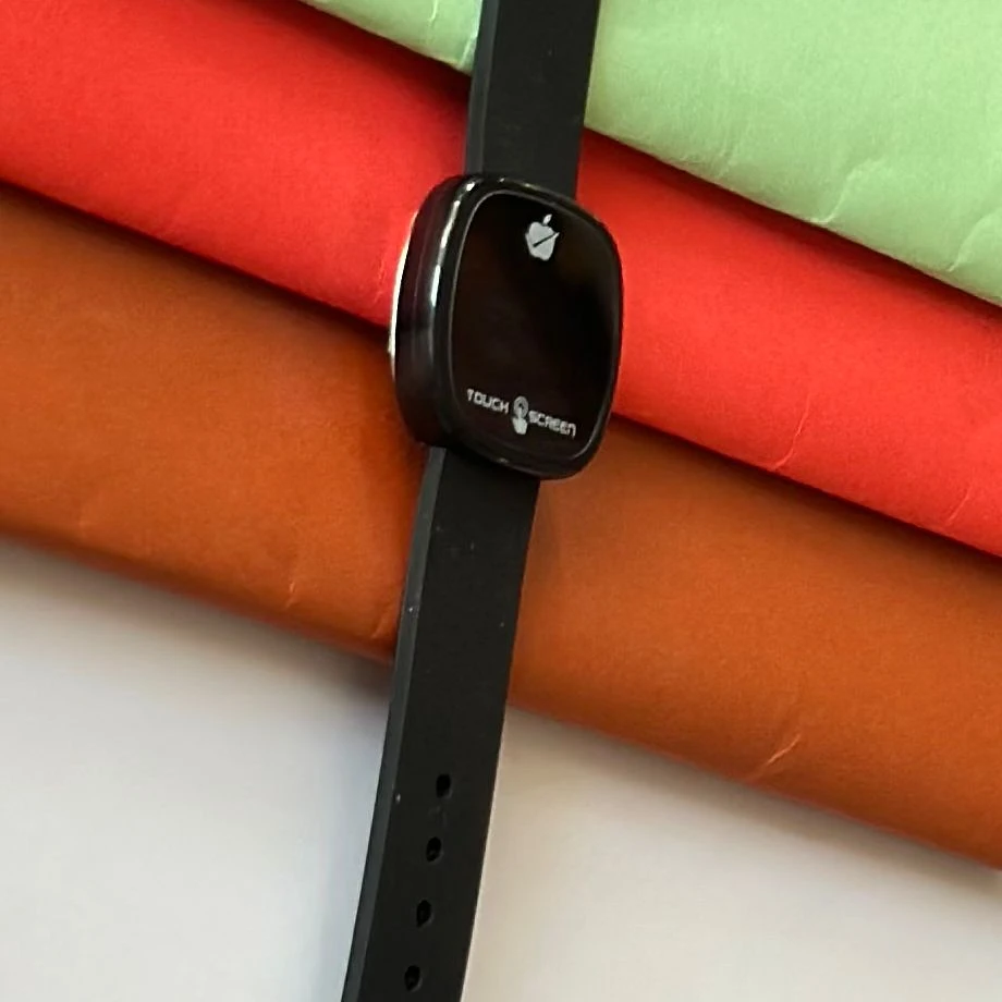 pink silicone strap and a gold-toned square dial.