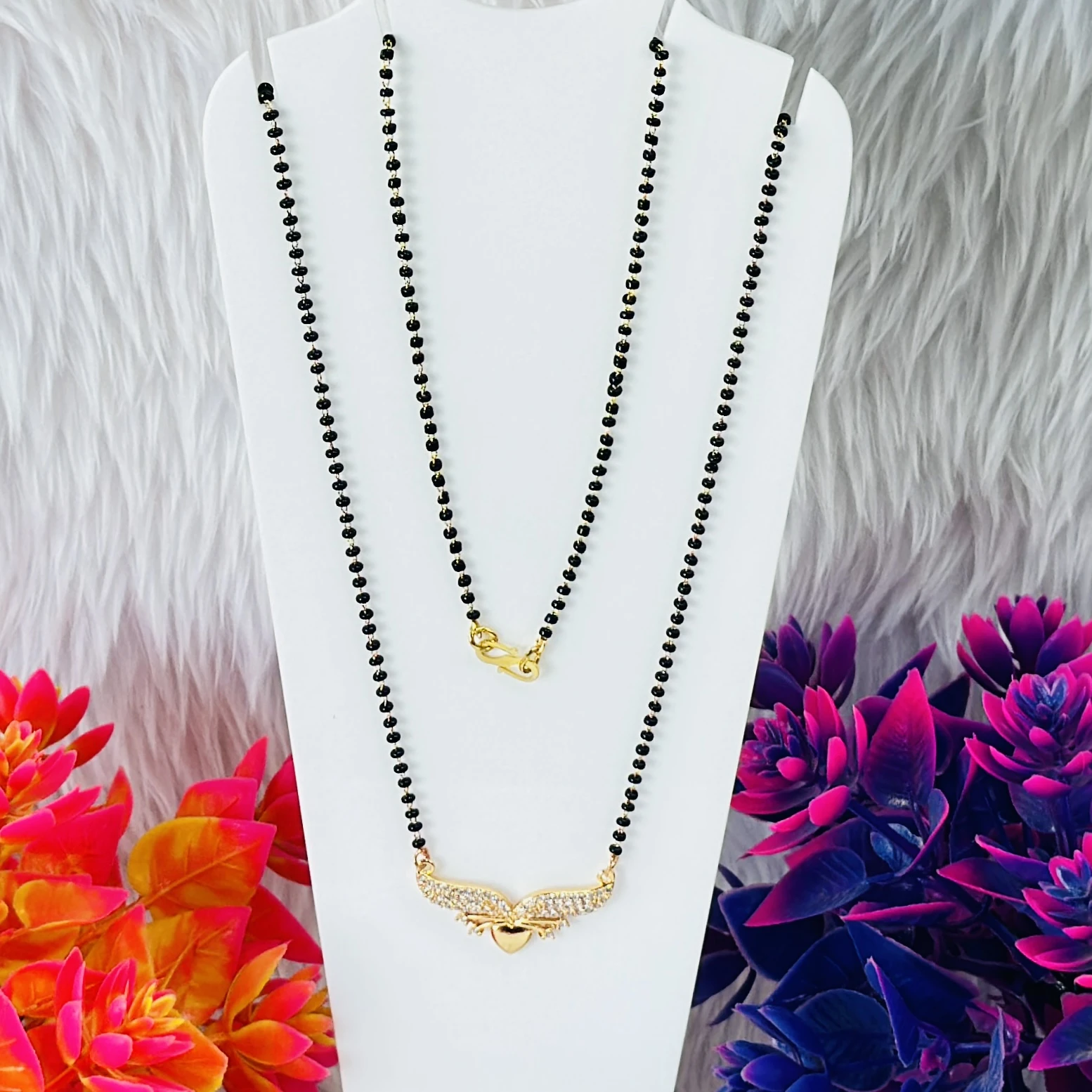 Gold plated mangalsutra with a cubic zirconia pendant.