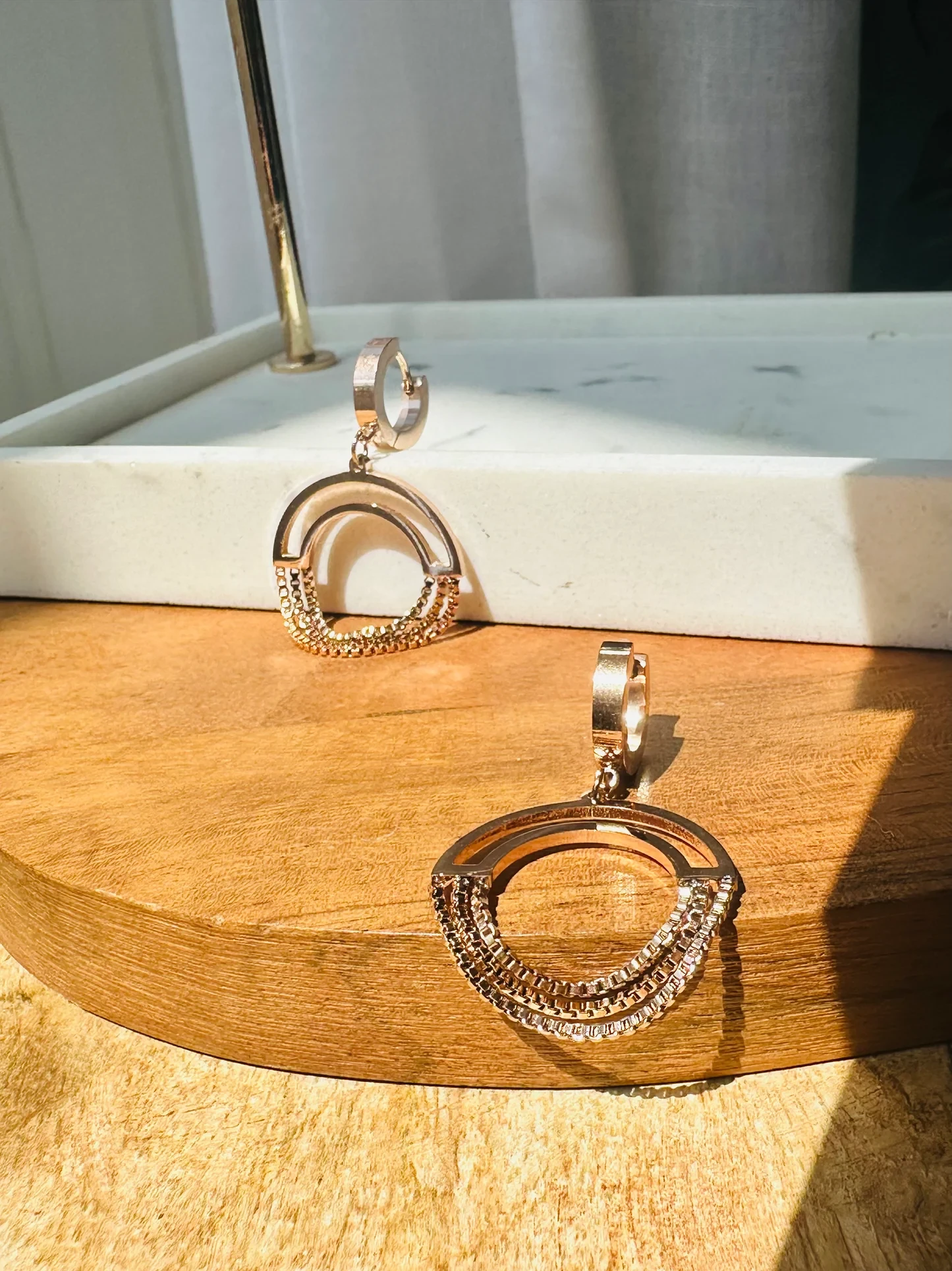 Gold plated chained circle drop earrings.