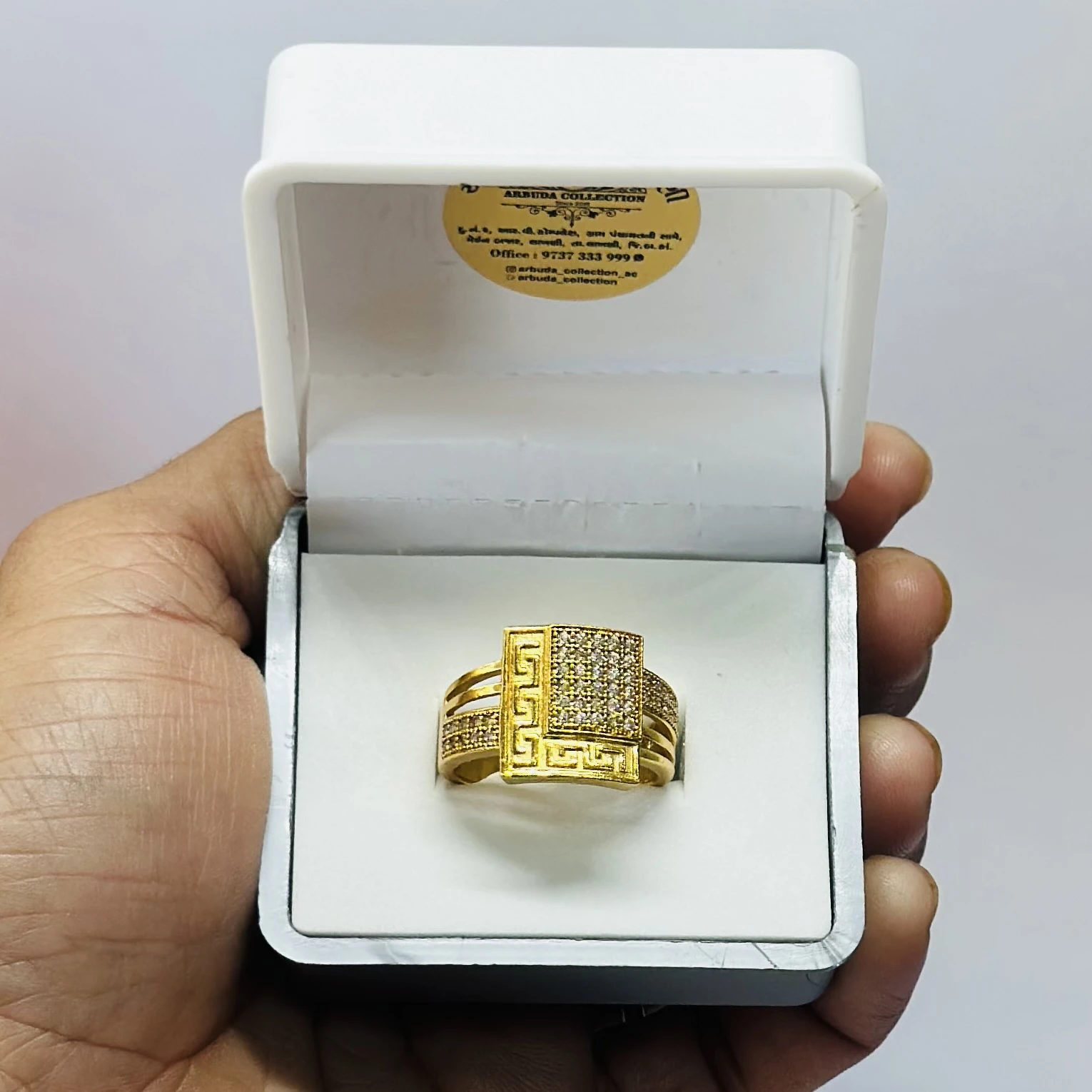 gold Greek Key cube engagement ring with diamonds.