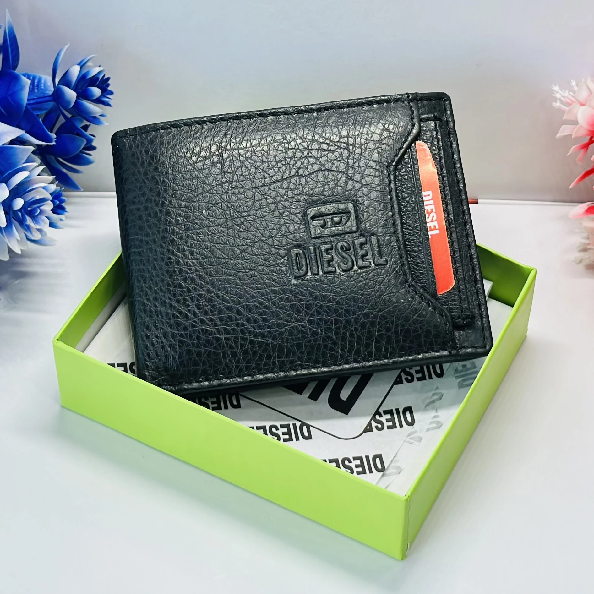 Diesel bi-fold wallet in black grainy leather.