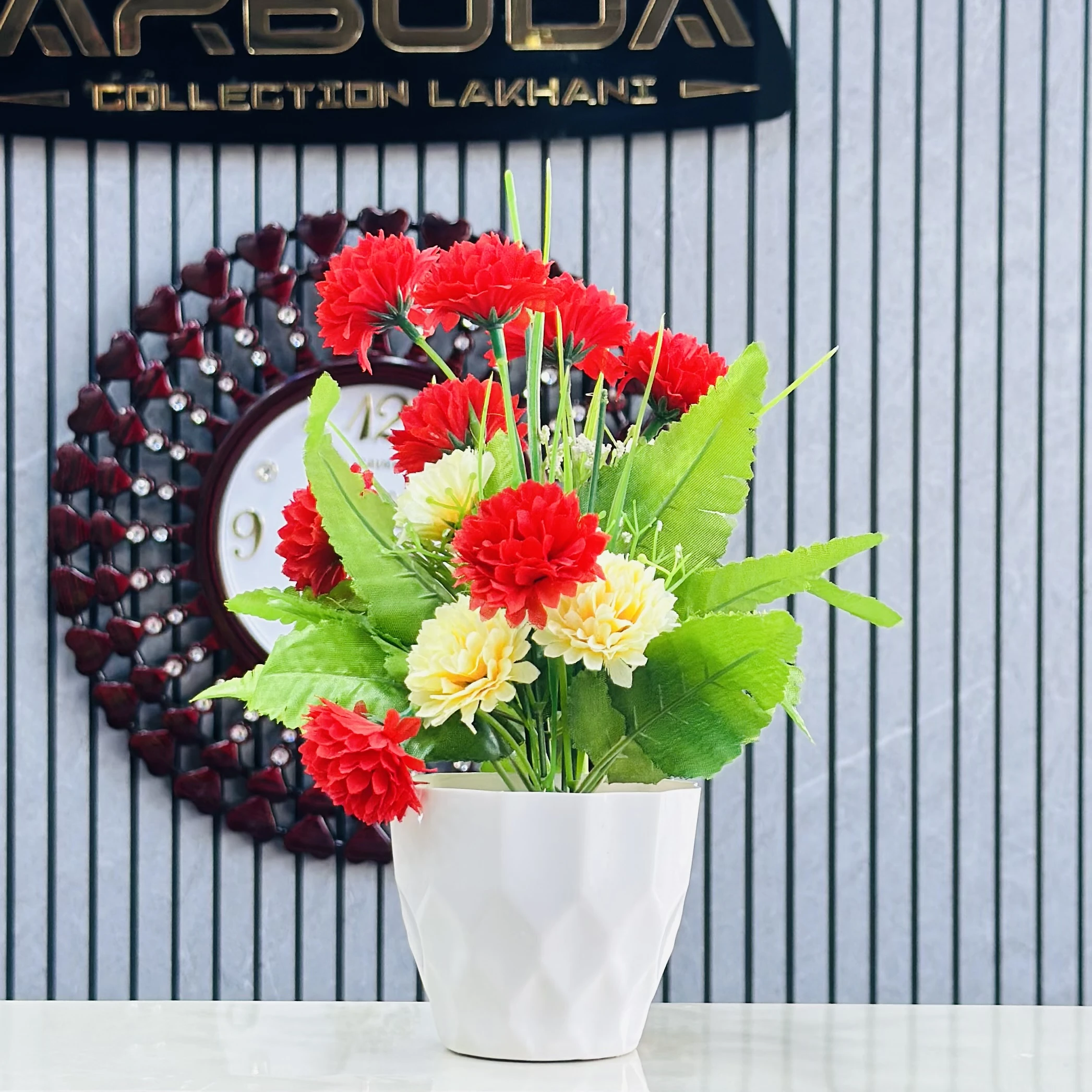 carnation flower arrangement in a white ceramic-like pot.