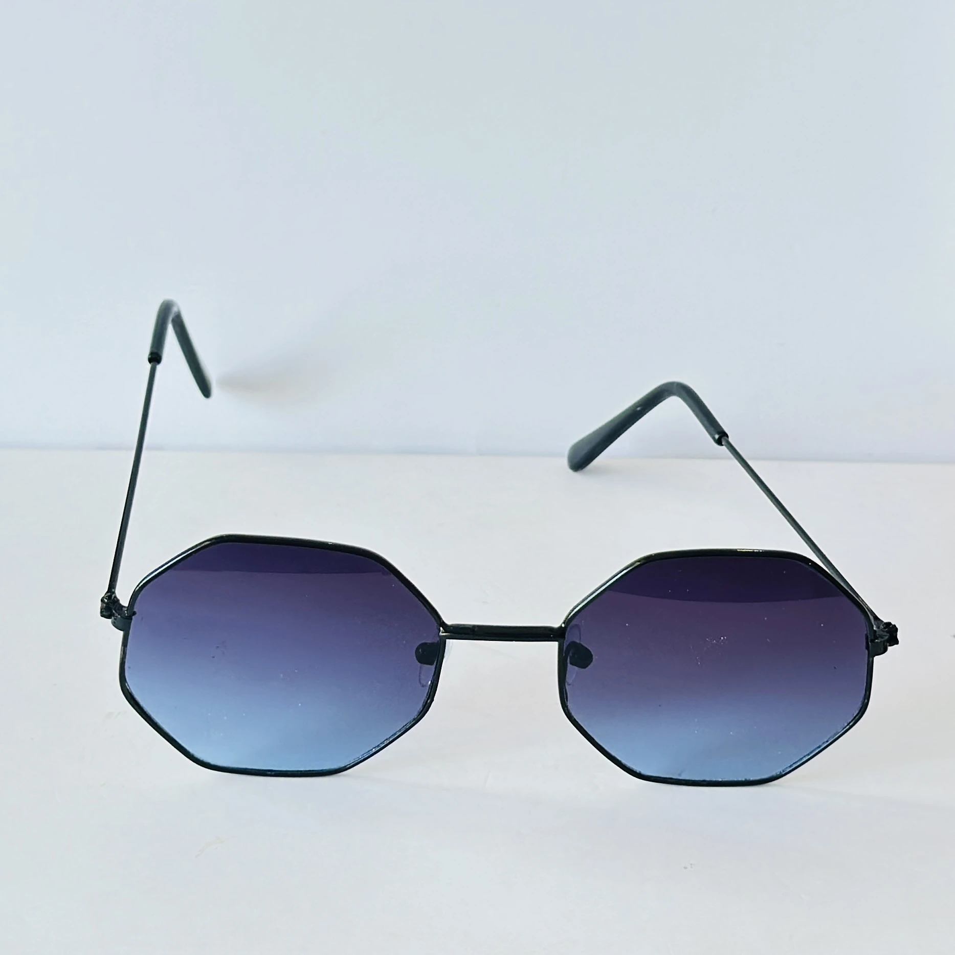 sunglasses appear to be similar to Vincent Chase Octagon Metal Frame Sunglasses