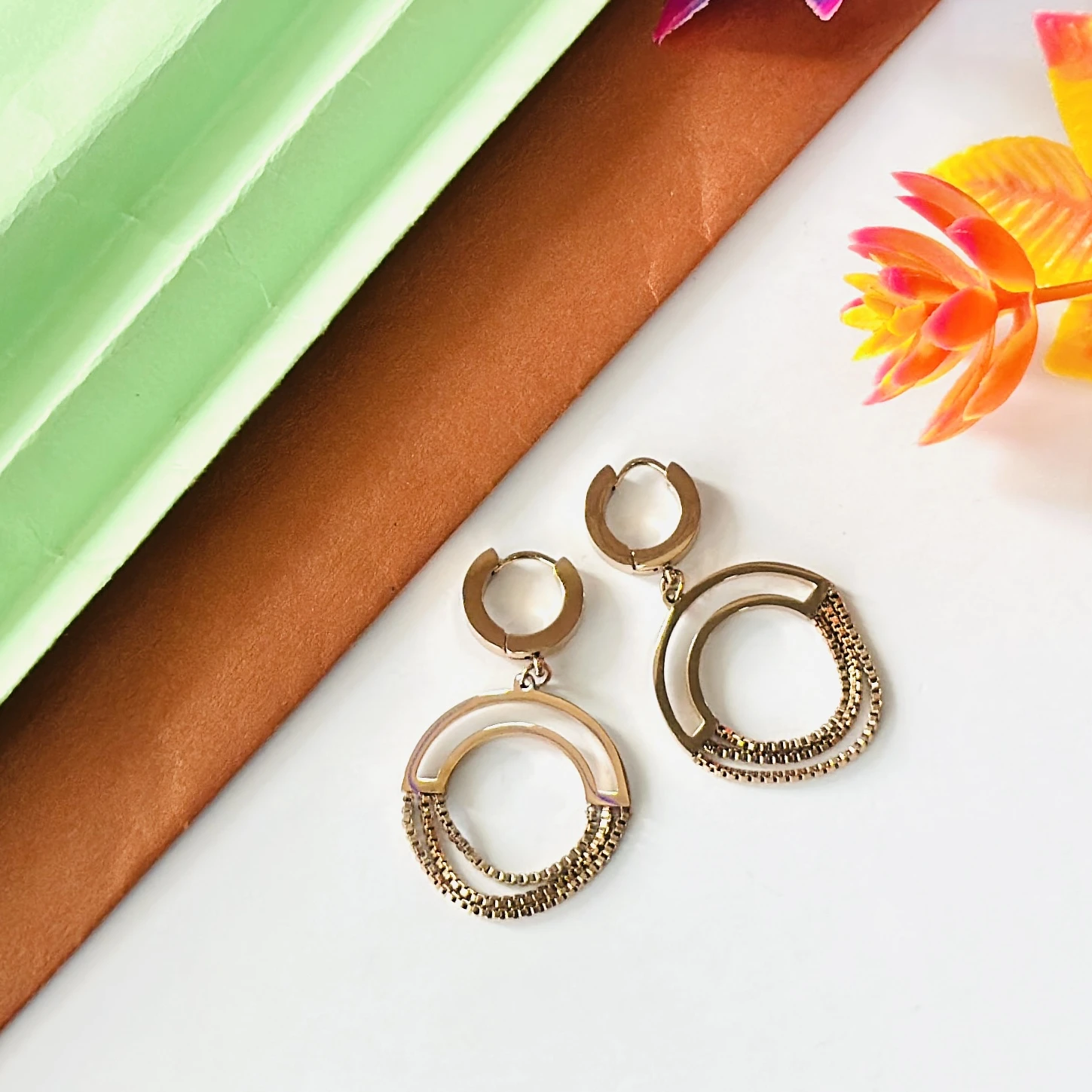Gold plated chained circle drop earrings.