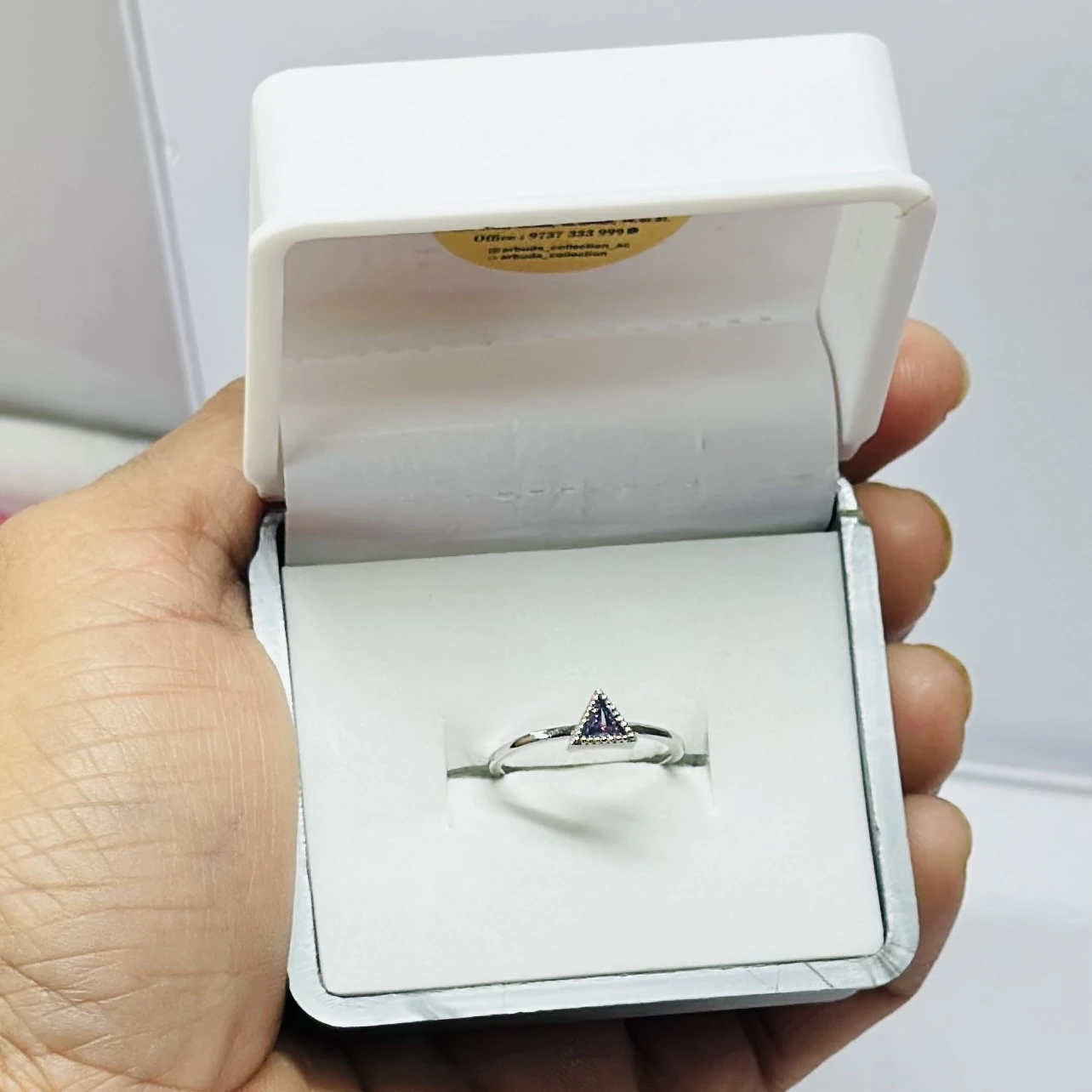 Gold solitaire engagement ring with a single round clear gemstone.