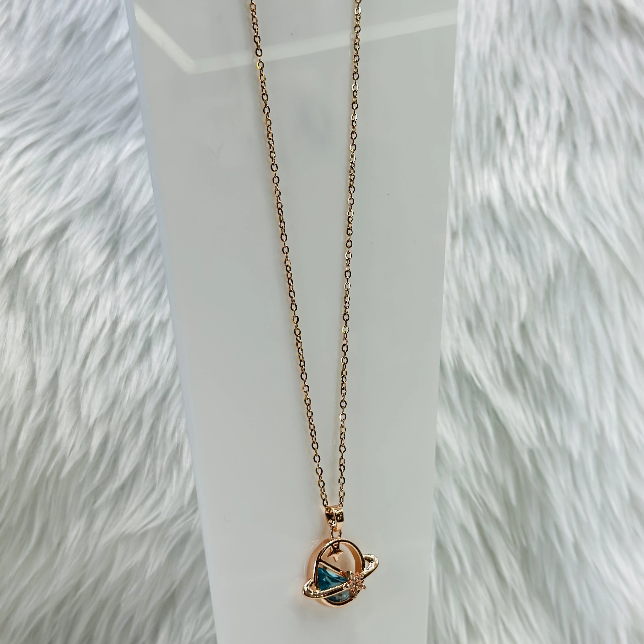 Rose gold tone planet pendant