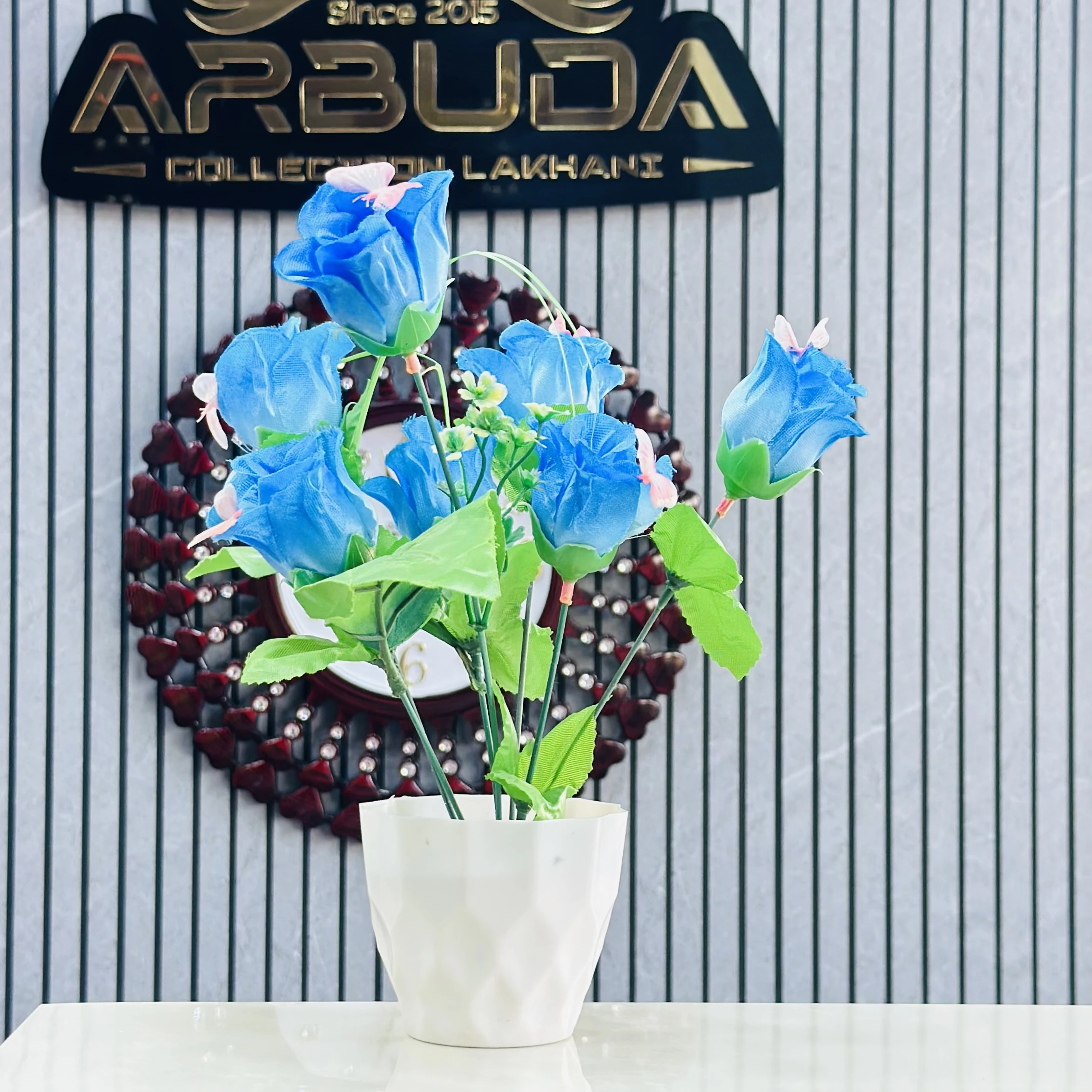 Blue rose flower bunch in a white plastic pot.
