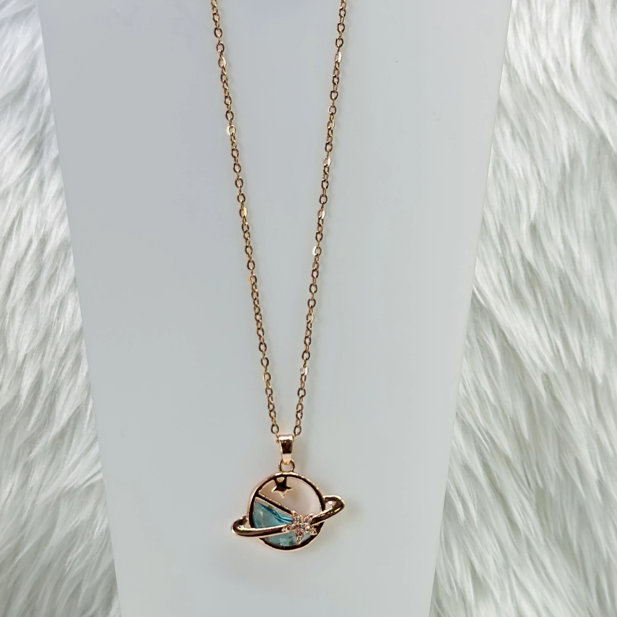 Rose gold tone planet pendant