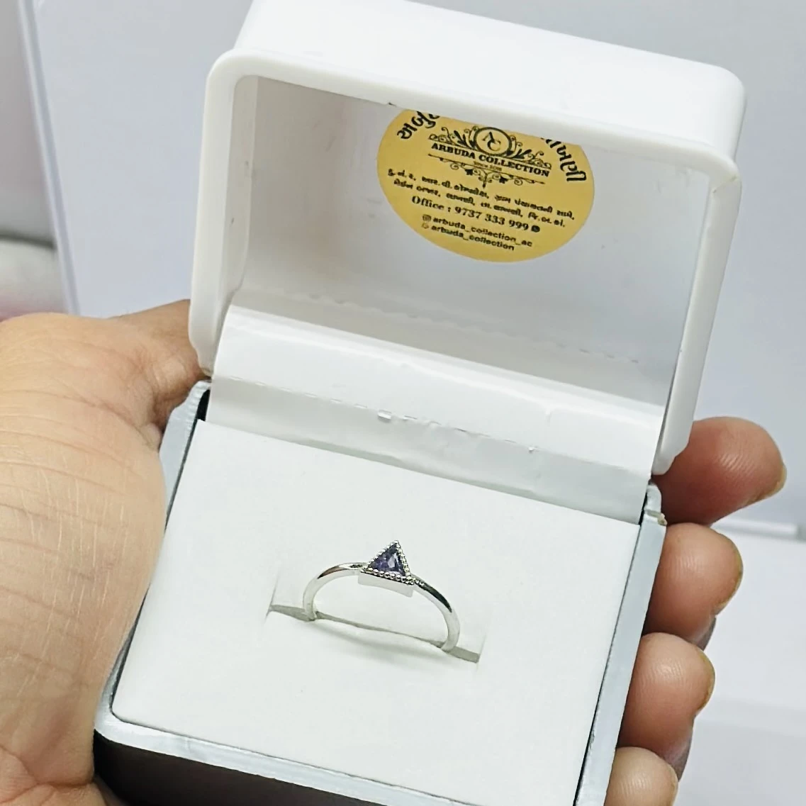 Gold solitaire engagement ring with a single round clear gemstone.