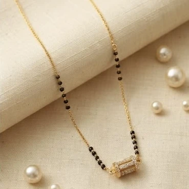 Peprika mangalsutra features a cylindrical pendant studded with American diamonds on an 18-inch black beaded chain
