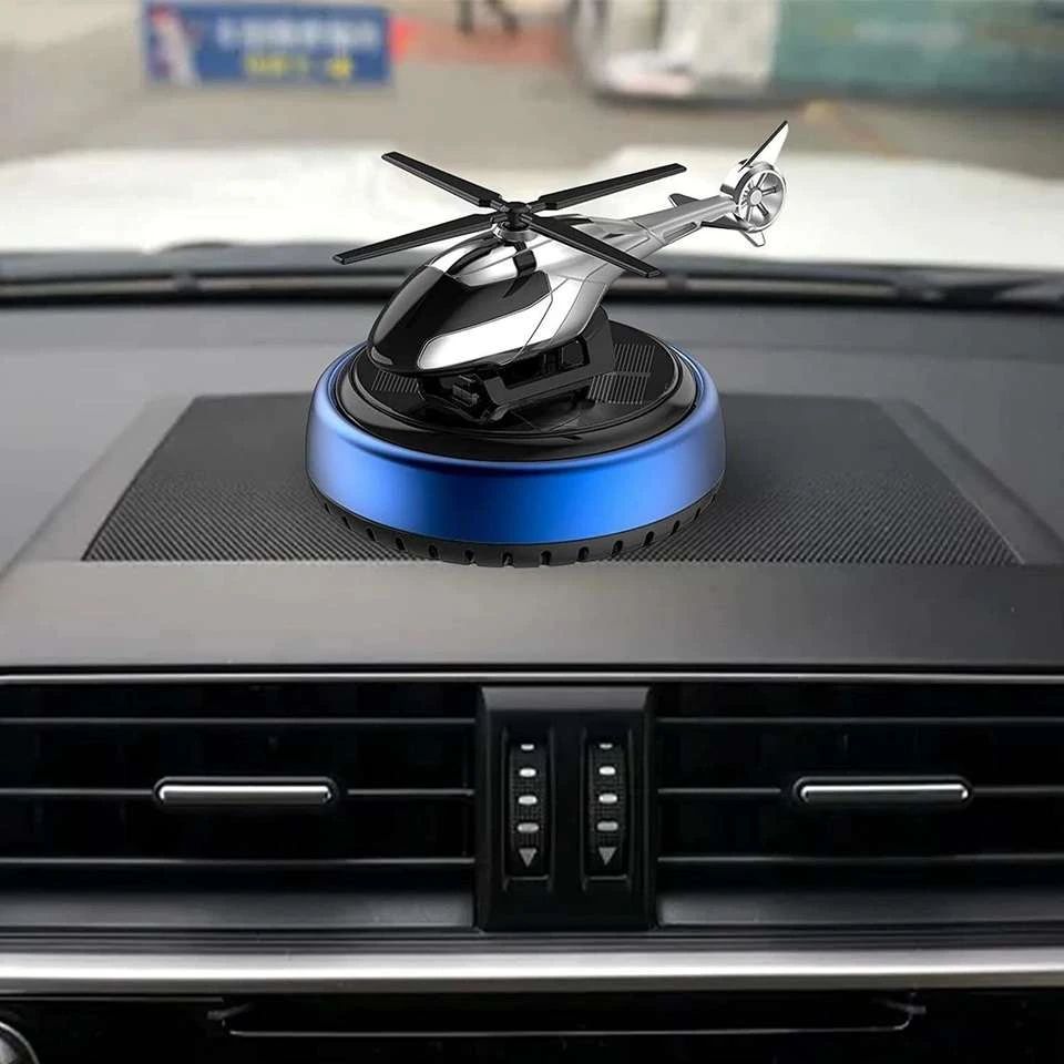 solar-powered helicopter car air freshener features a silver alloy aircraft model.