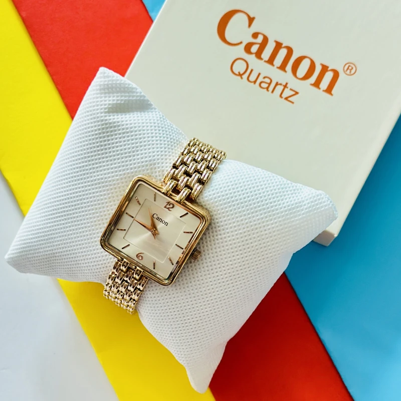 an elegant gold-tone Canon Quartz analog watch