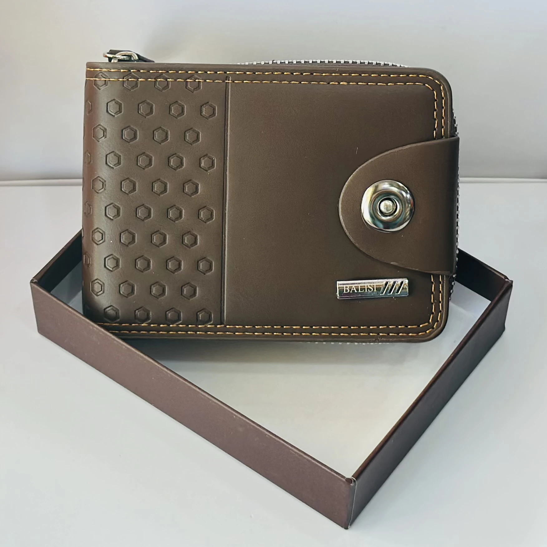 Balisi brown leather men's bifold wallet with a button closure.