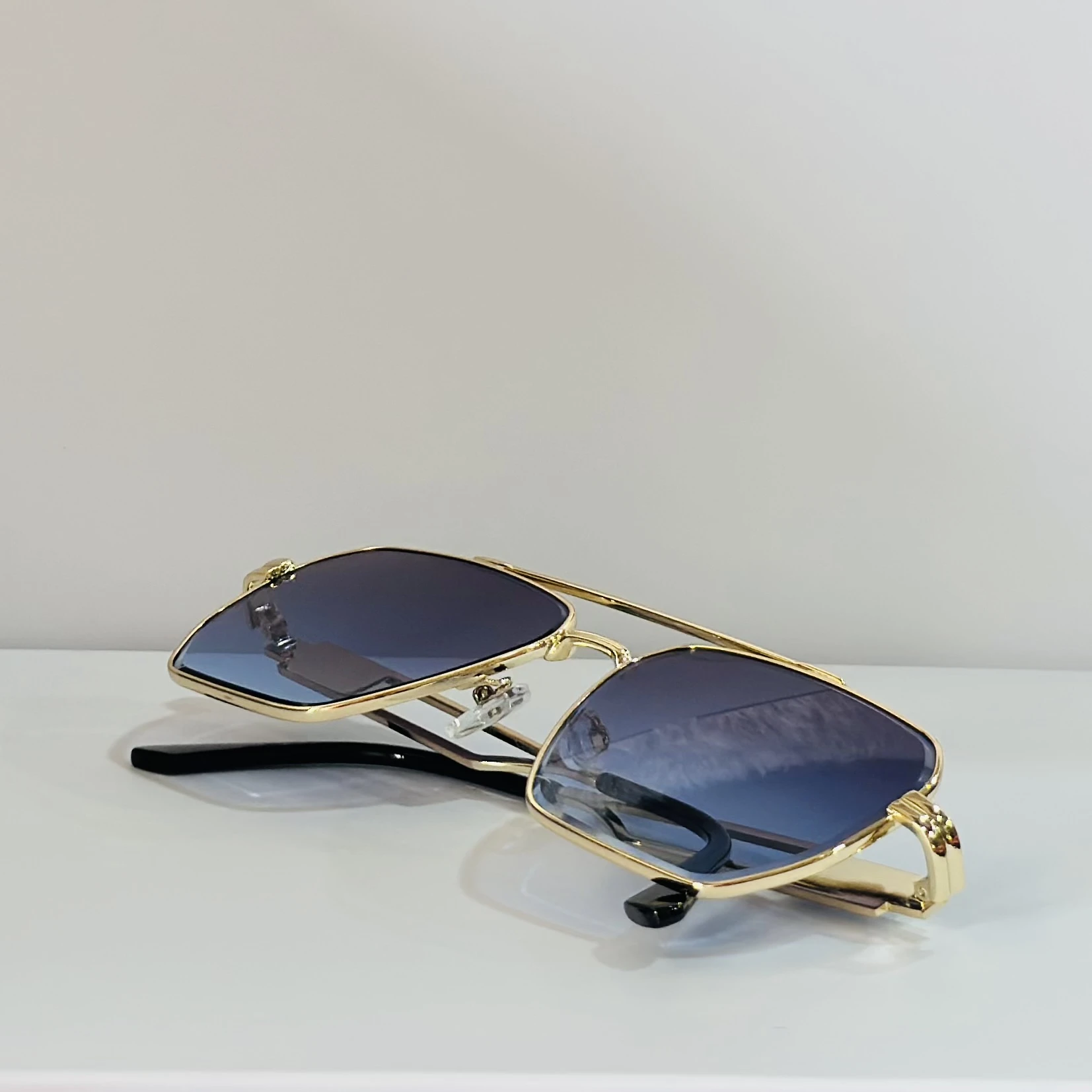 pair of gold-toned aviator sunglasses with gradient lenses.
