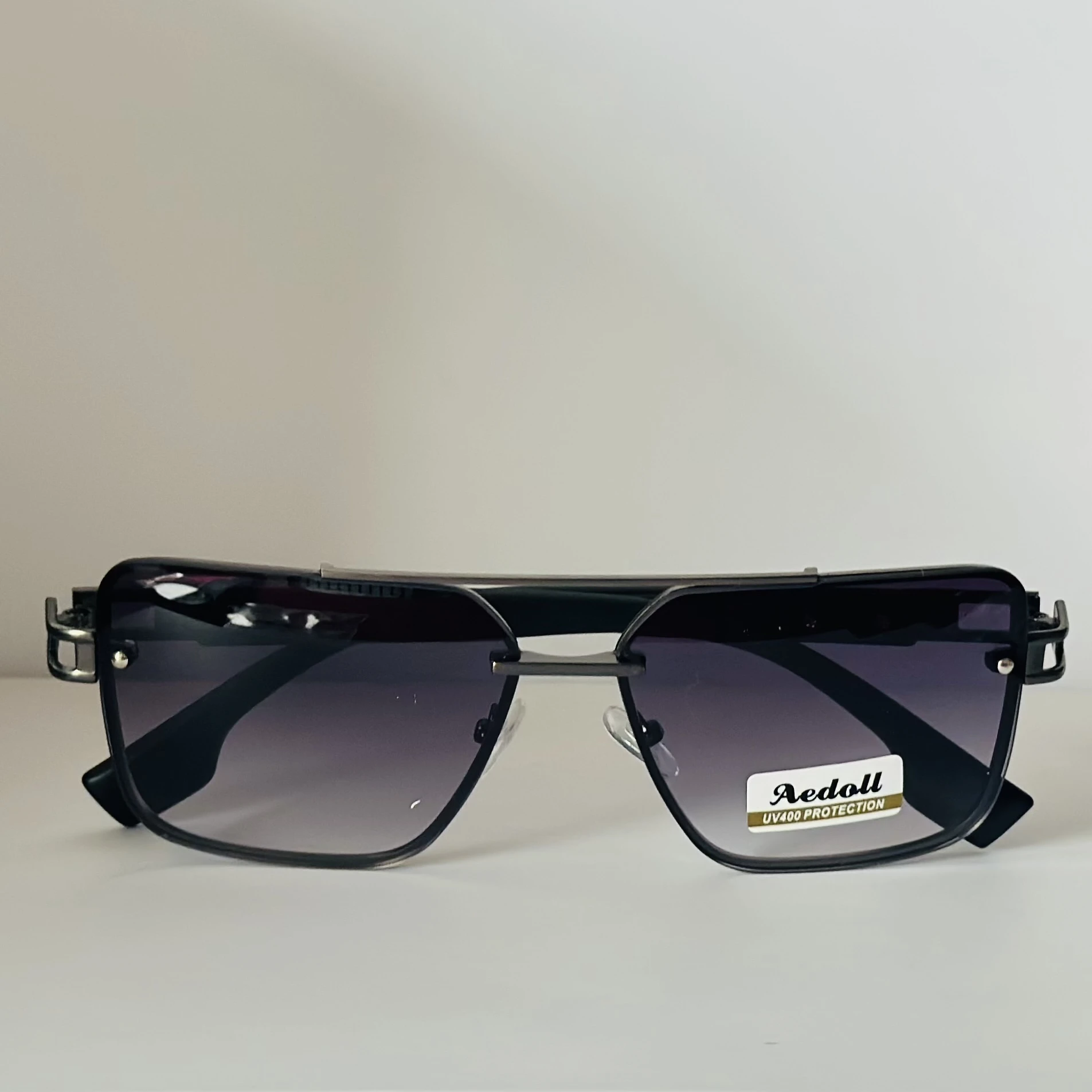 pair of Aedoll Goggle sunglasses with a gold metal frame and pink gradient lenses.