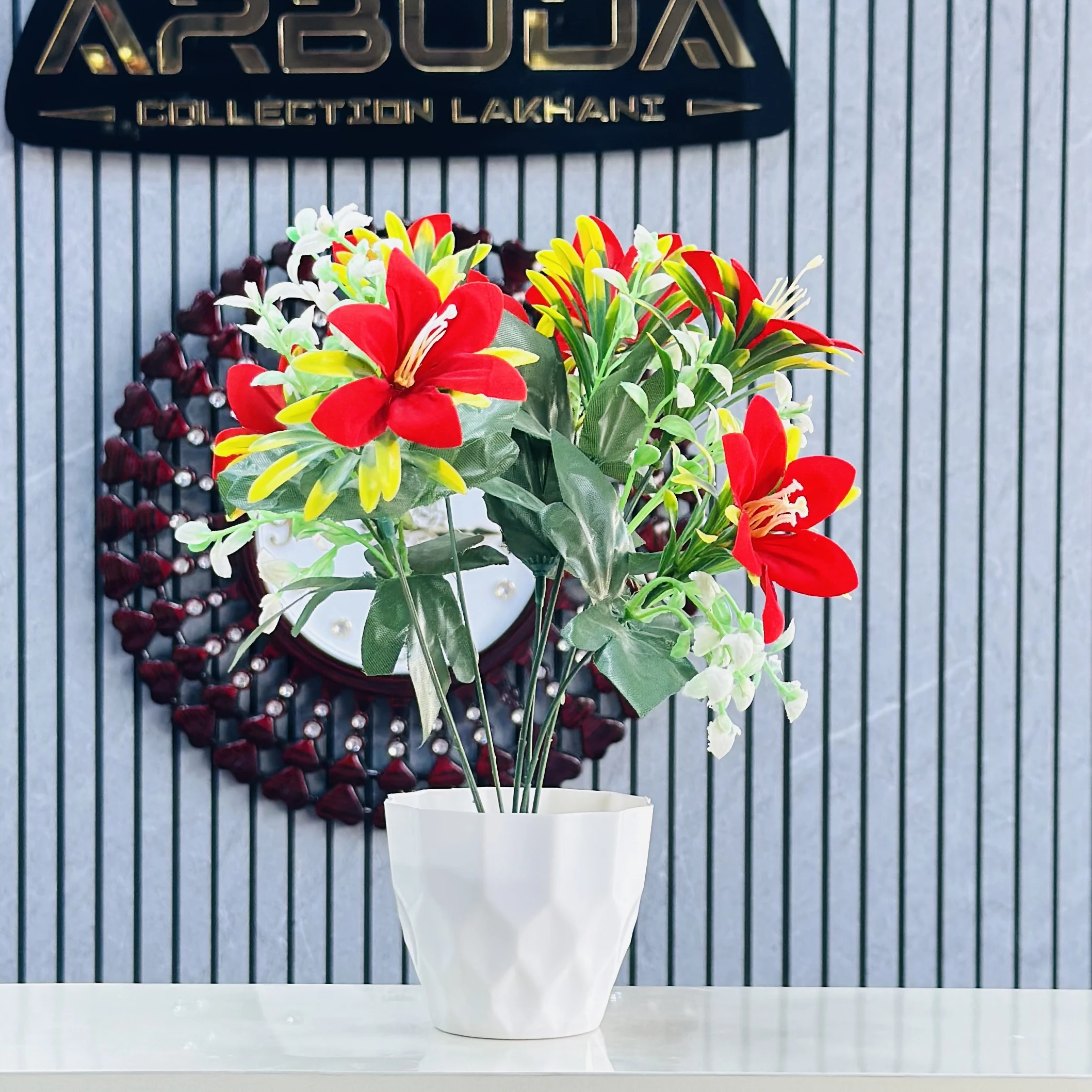 lily flower arrangement in a white pot.