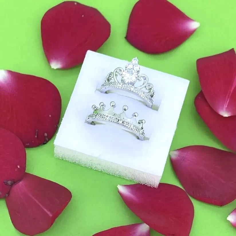 Set of silver-plated, cubic zirconia-studded, adjustable crown couple rings.