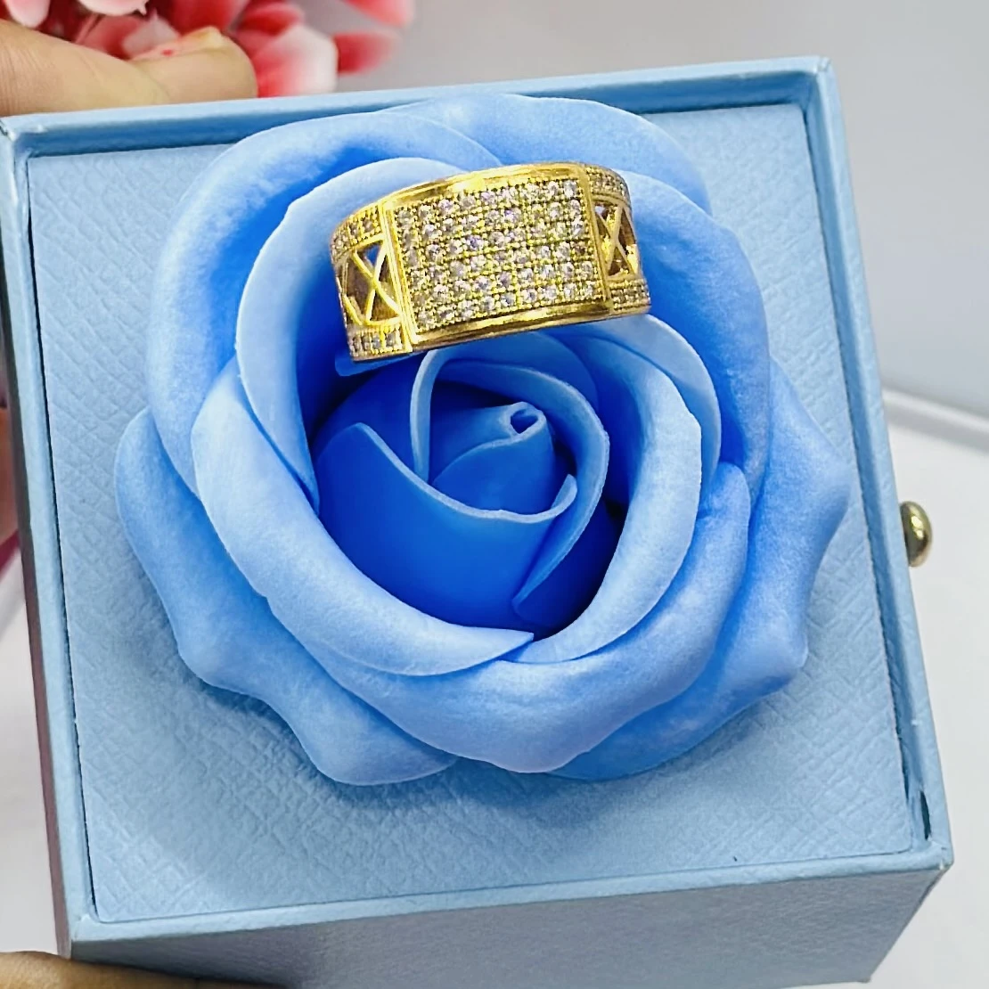 gold-toned men's ring featuring a rectangular face with multiple inset diamonds.
