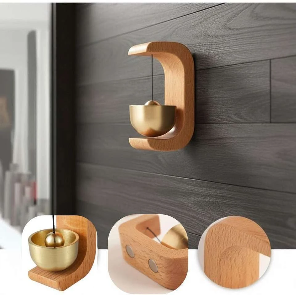 magnetic door chime featuring a brass bell and a light-colored beech wood stand.