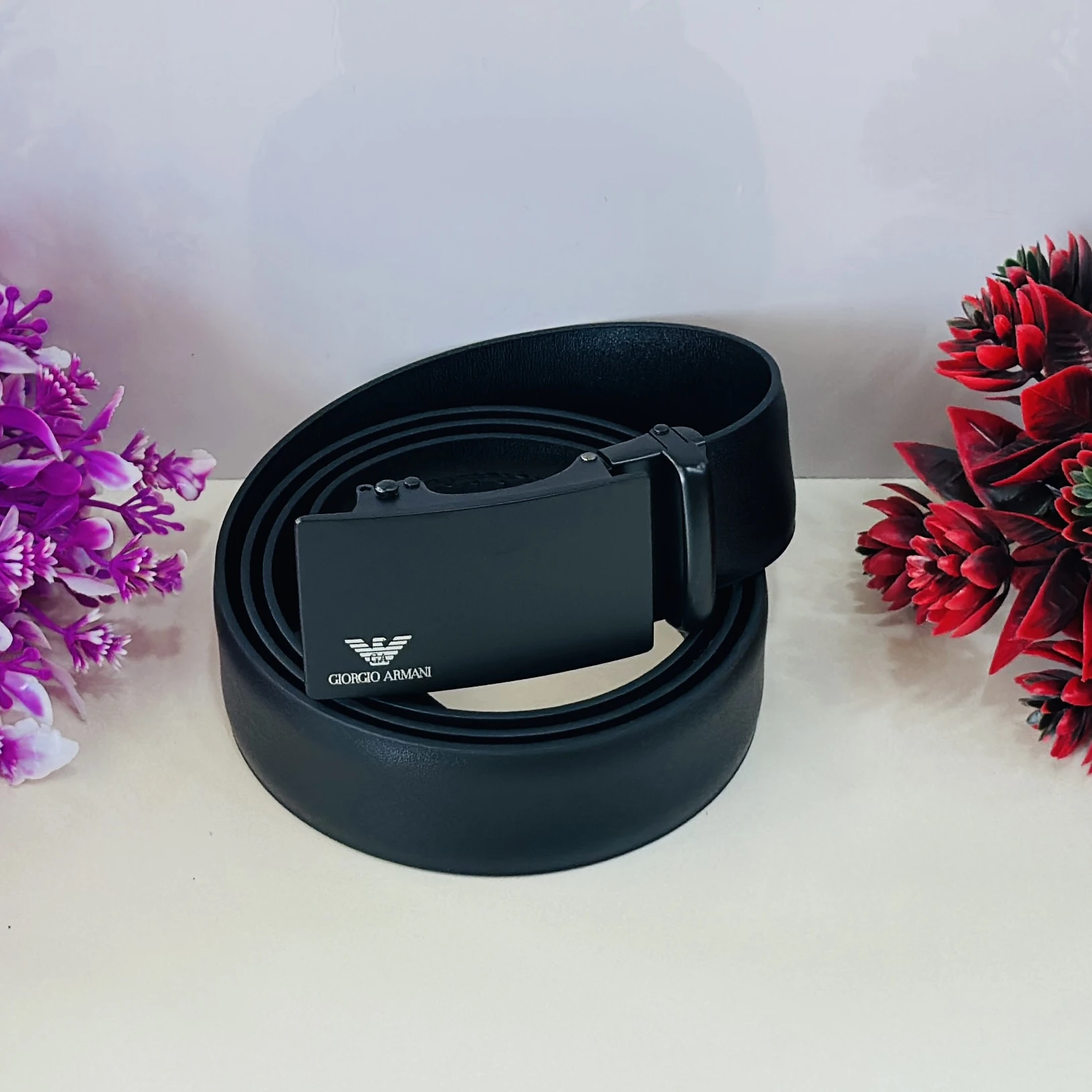 Emporio Armani black leather belt with a logo plaque buckle.