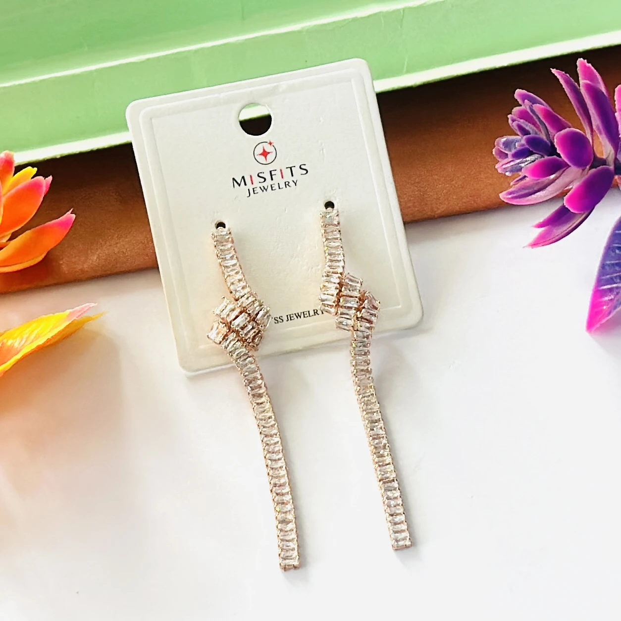 Lovisa gold-plated cubic zirconia baguette knotted drop earrings.