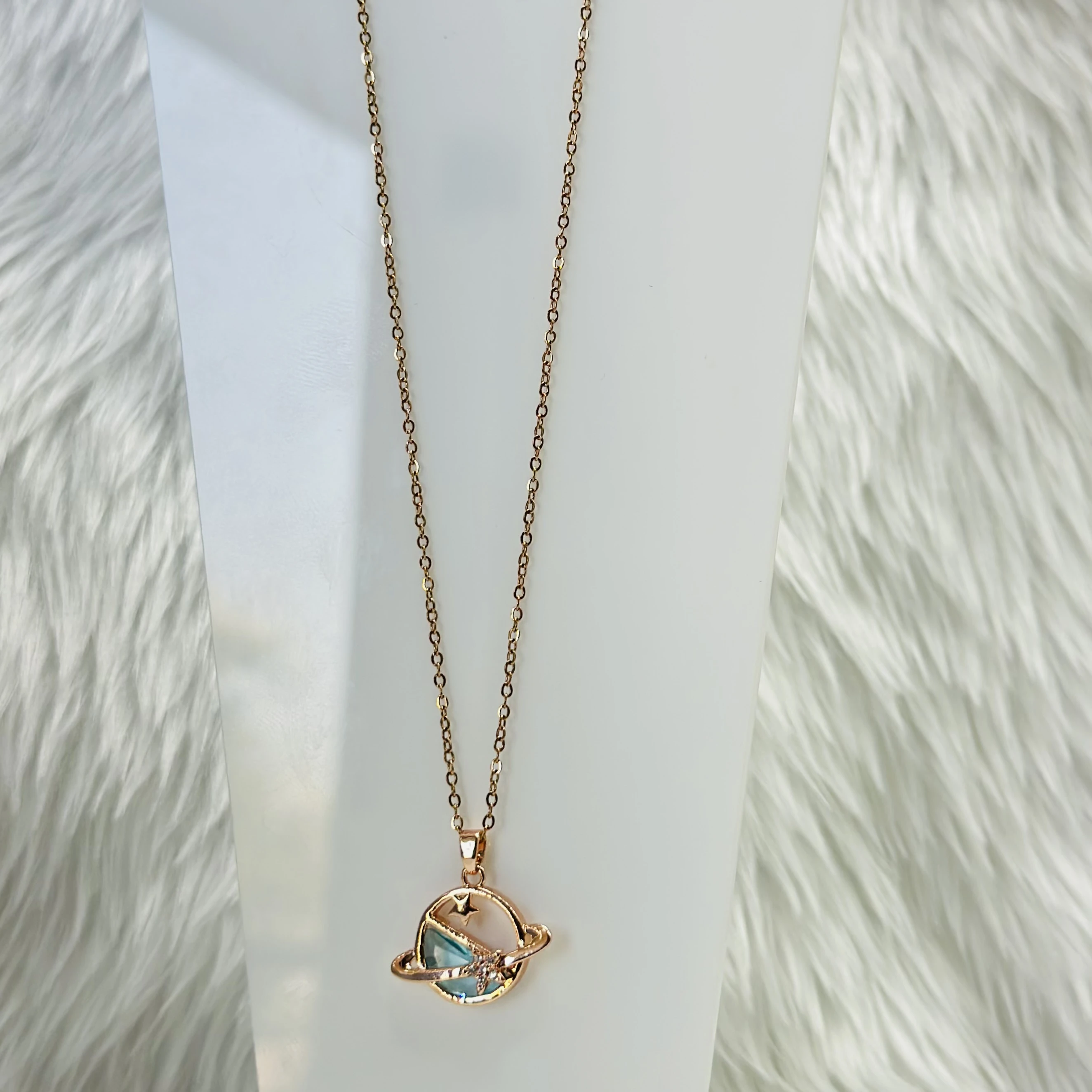 Rose gold tone planet pendant