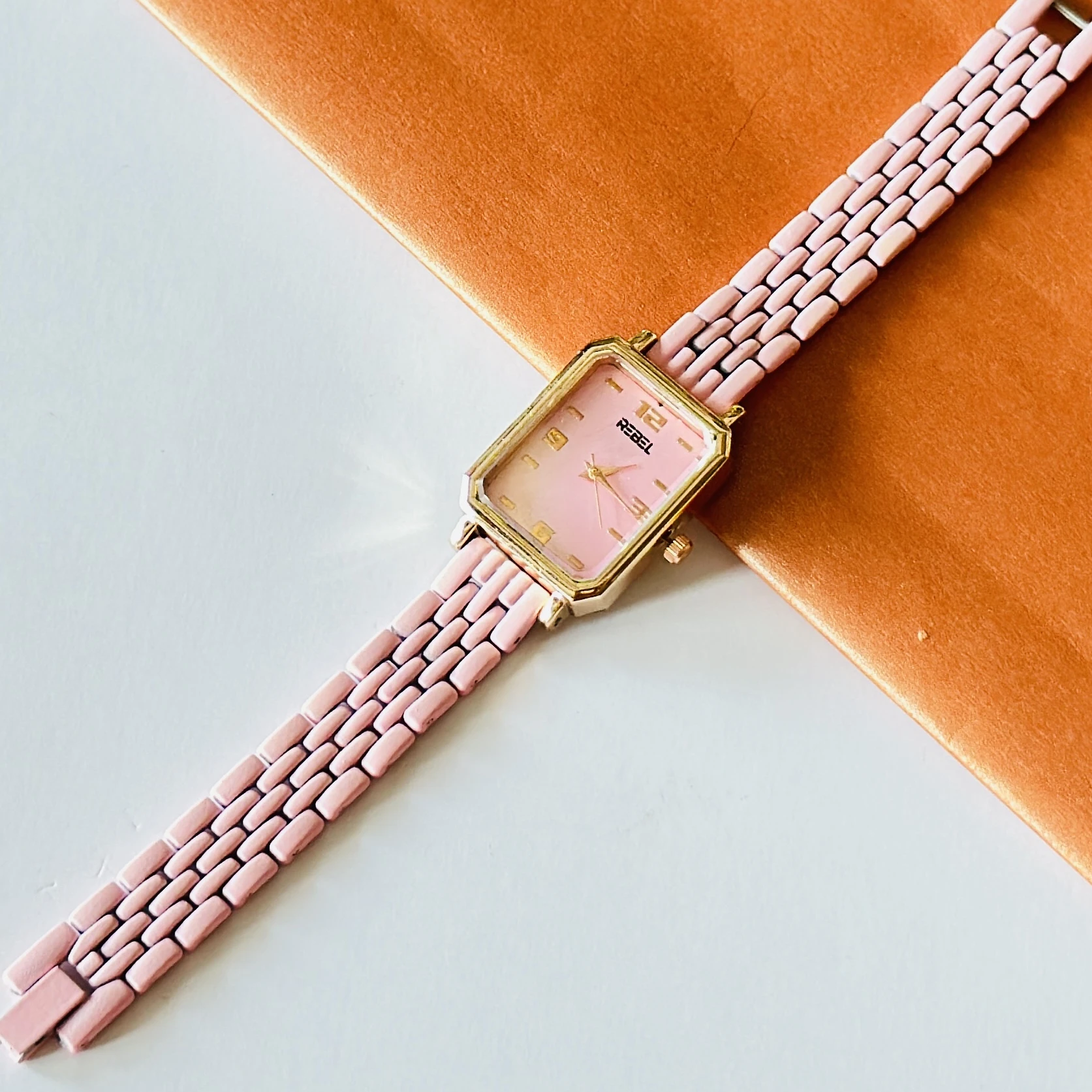 Rebel quartz watch with a pink dial and matching strap.