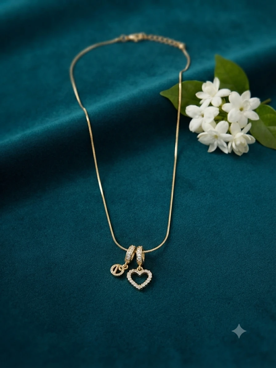 gold-plated necklace features a charming heart-shaped pendant studded with small crystals.