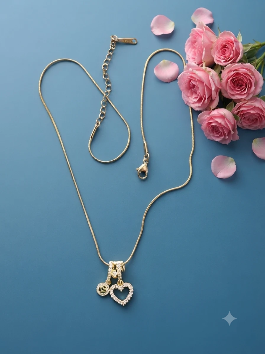 gold-plated necklace features a charming heart-shaped pendant studded with small crystals.