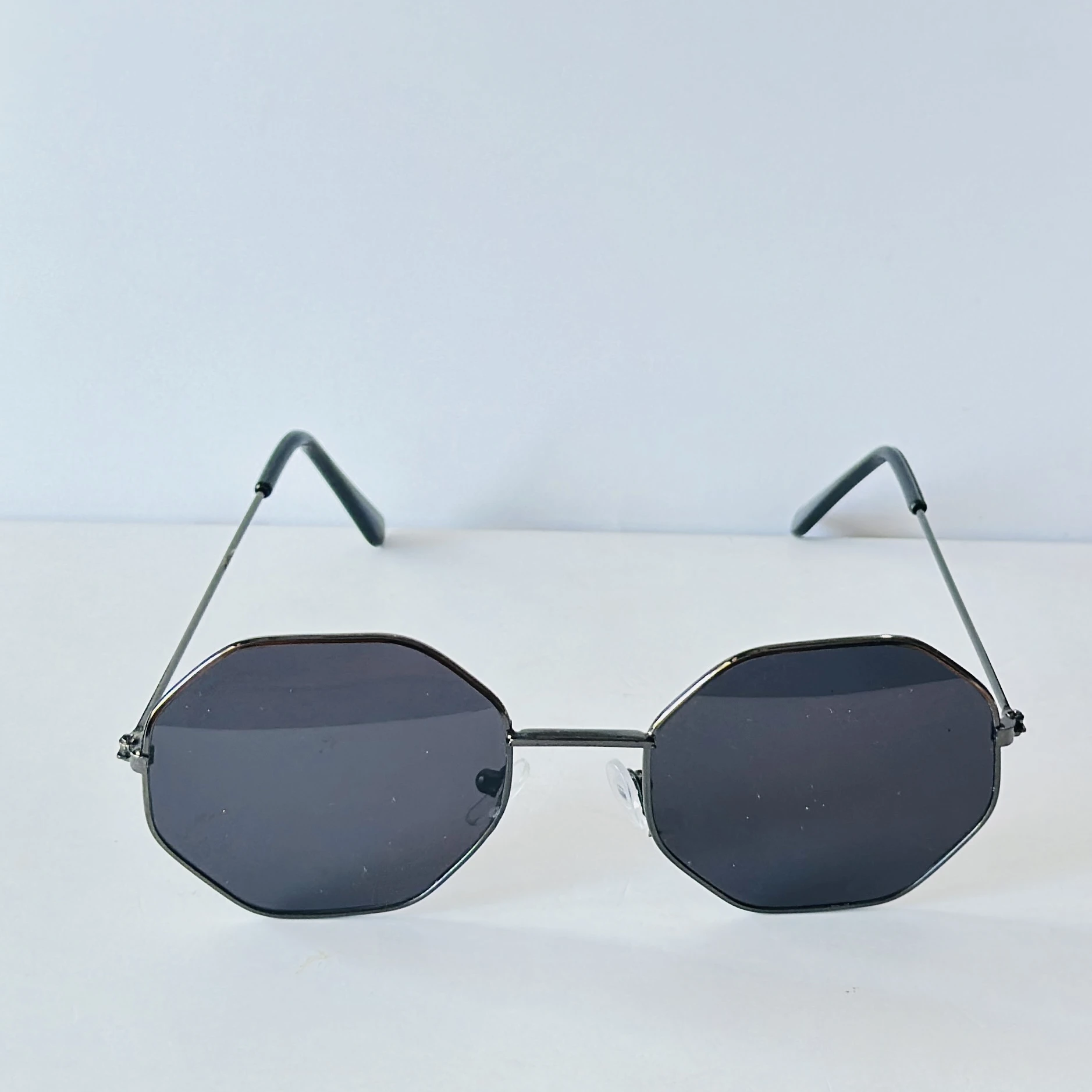 sunglasses appear to be similar to Vincent Chase Octagon Metal Frame Sunglasses