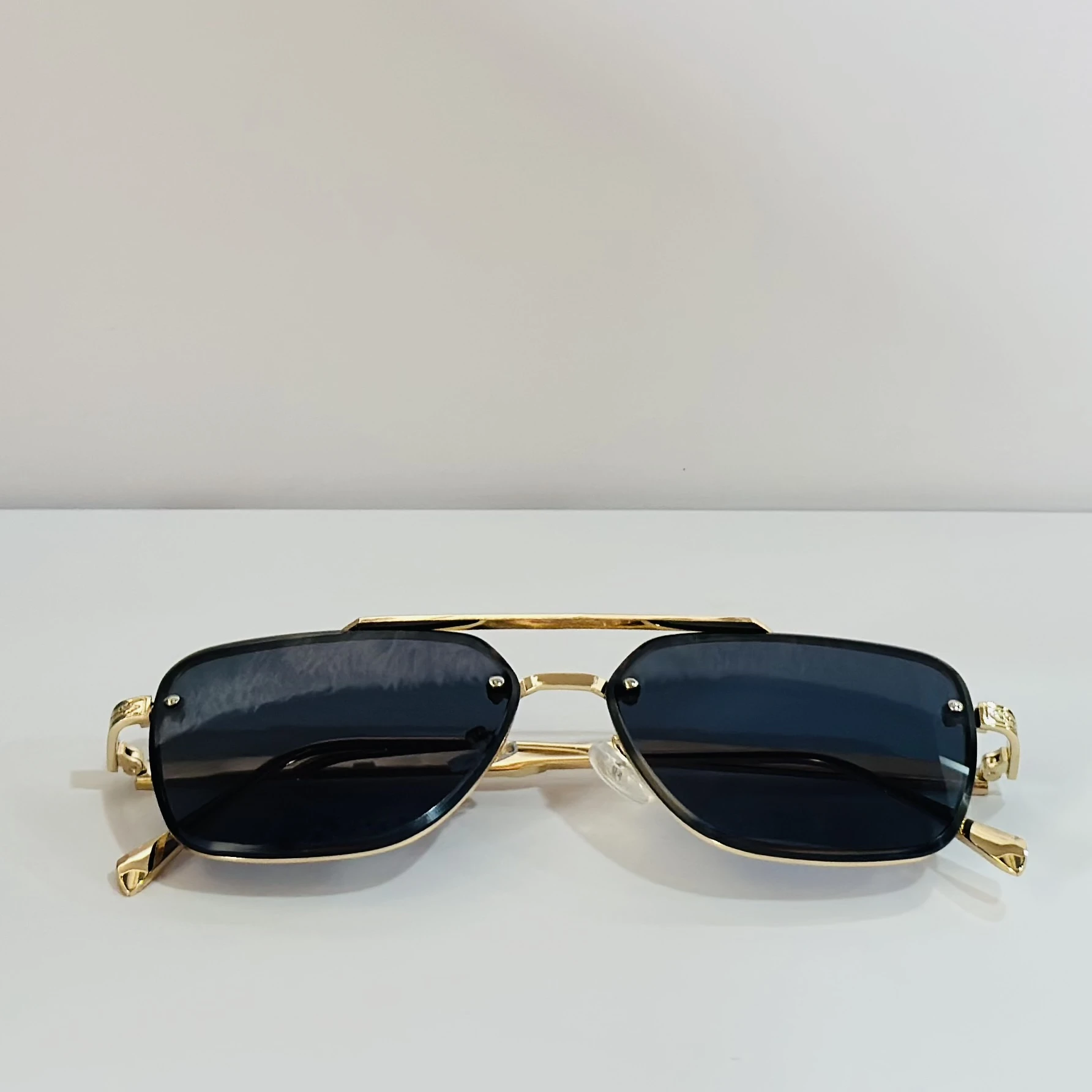 pair of Versace VE 2275 sunglasses with a gold metal frame and black/grey lenses.